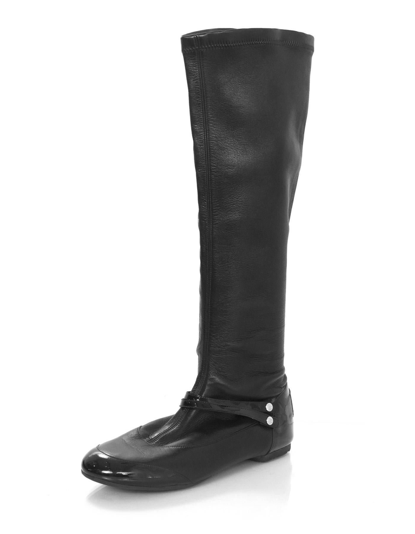 Chanel Black Leather Boots Sz 36
Features patent leather heels, toes, and straps across ankle

Made In: Italy
Color: Black
Materials: Leather, patent leather
Closure/Opening: Pull on
Sole Stamp: Made in Italy 36
Overall Condition: Excellent