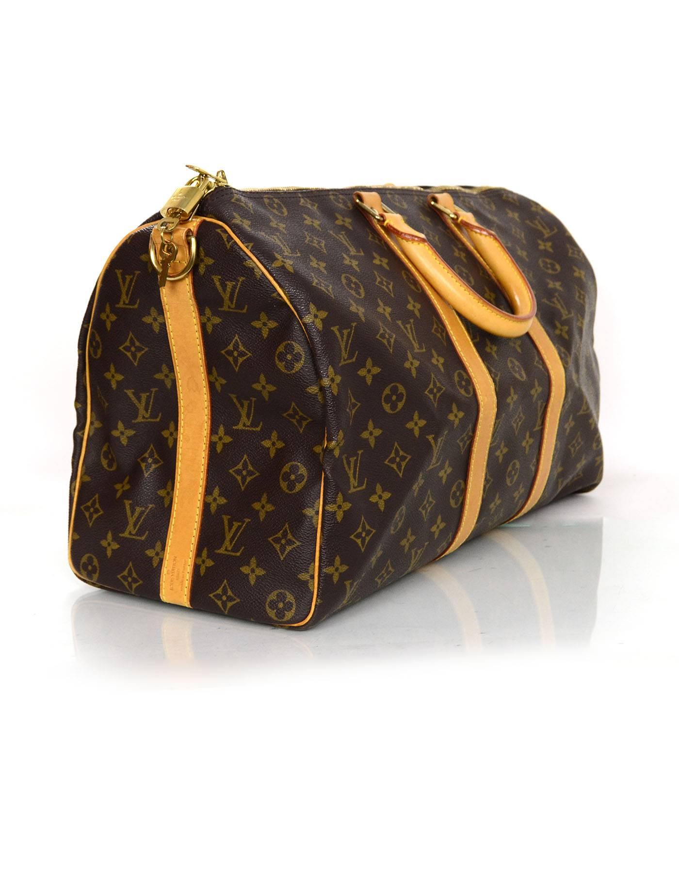 Louis Vuitton Monogram Keepall Bandouliere 45 

Made In: France
Year of Production: 1996
Color: Brown and tan
Hardware: Goldtone
Materials: Coated canvas and leather
Lining: Brown canvas
Closure/Opening: zip across top
Exterior pockets: