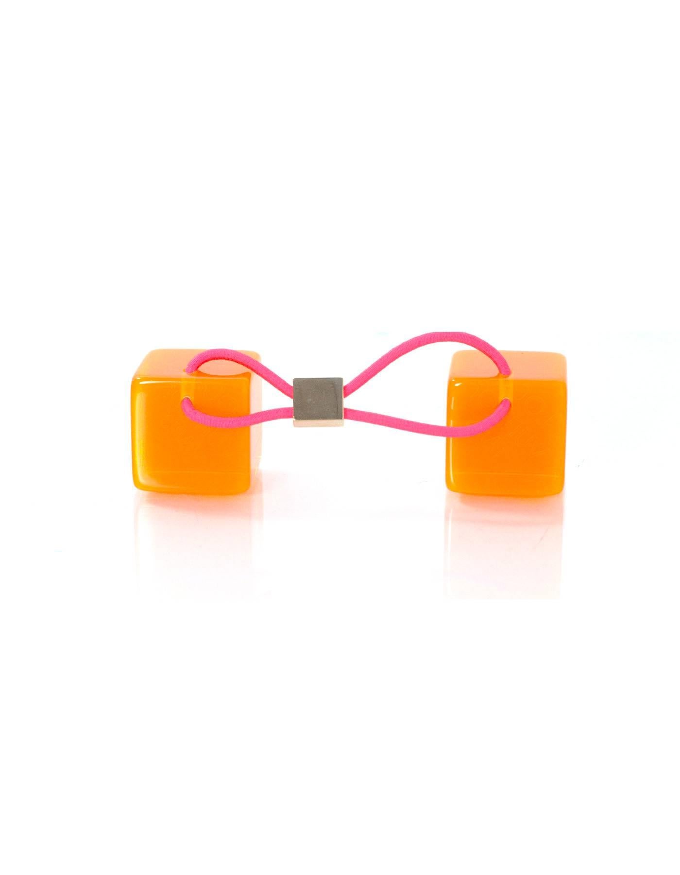 Louis Vuitton Orange Hair Cubes

Color: Orange
Hardware: Goldtone
Materials: Lucite, brass, elasticized band
Retail Price: $295 + tax
Overall Condition: Excellent pre-owned condition with the exception of some surface marks

Measurements: 
1"L