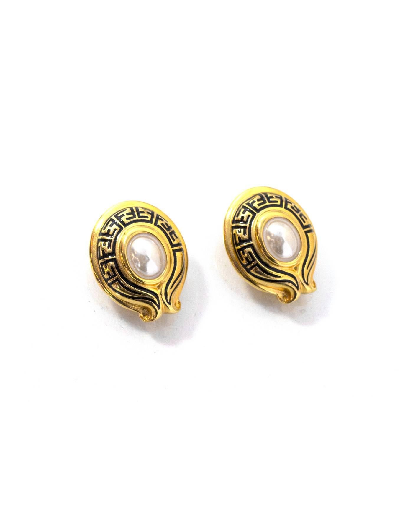 Fendi Goldtone and Pearl Clip-On Earrings
Features Fendi logo bordering faux pearl

Color: Goldtone and faux pearl
Materials: Faux pearl and metal
Closure: Clip on
Stamp: Fendi
Overall Condition: Excellent vintage pre-owned vintage condition with