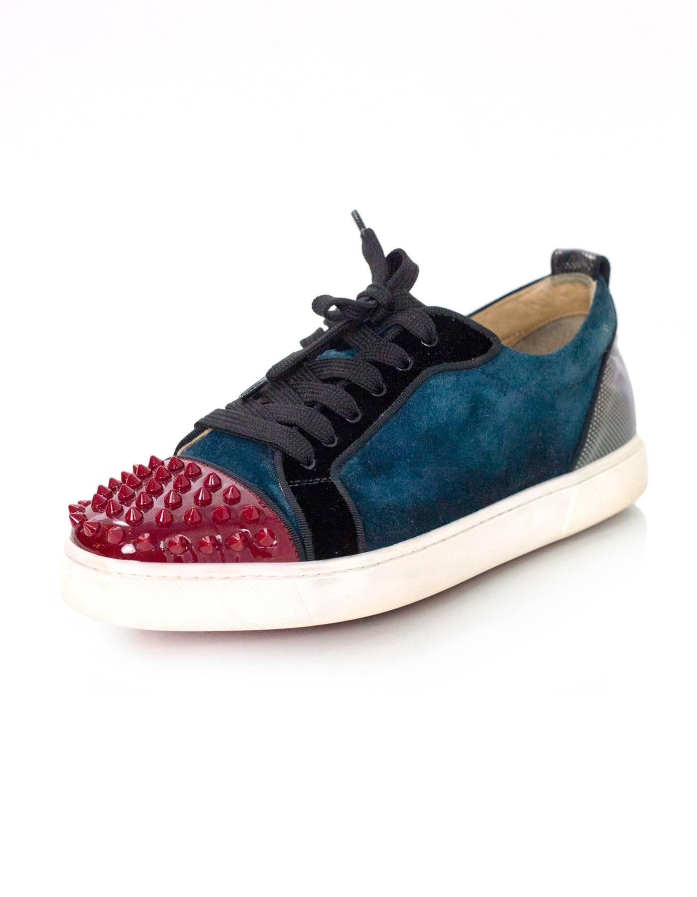 Christian Louboutin Teal & Red Louis Jr Sneakers Sz 40
Features studded cap toes and geometric print heels

Made In: Italy
Color: Teal, red, black
Materials: Velvet, patent leather
Closure/Opening: Lace tie closure
Sole Stamp: Christian