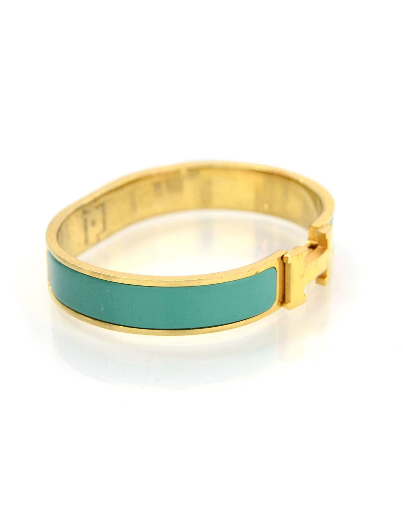 Hermes Turquoise & Gold Narrow H Clic Clac GM

Color: Turquoise
Hardware: Goldtone
Materials: Enamel and metal
Closure/Opening: Swivel H closure
Stamp: HERMES M
Retail: $600 + tax
Overall Condition: Good pre owned condition with the exception of