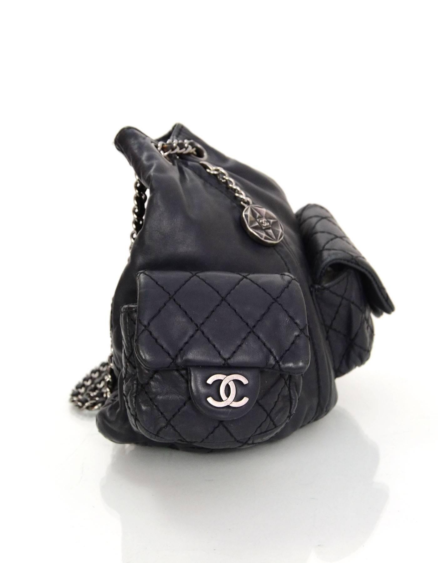 Chanel Black Quilted Mini 'Backpack is Back' Bag 
Features CC charm at front zipper pull and two CC pendants on pockets

Made In: Italy
Year of Production: 2012
Color: Black
Hardware: Oxidized silvertone
Materials: Calfskin leather
Lining: Black