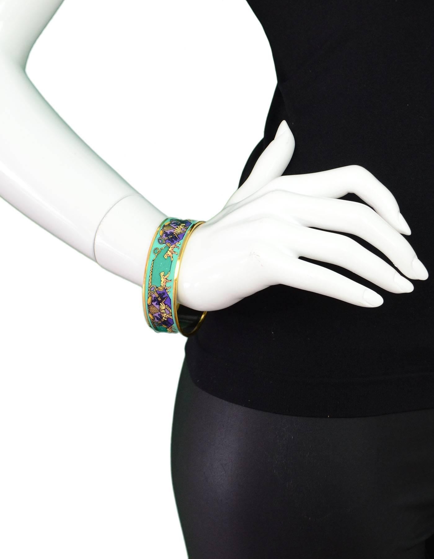 Hermes Turquoise and Purple Enamel Bracelet Sz 70
Features leopard and tiger design

Made In: Austria
Color: Turquoise, green, purple
Hardware: Goldtone
Materials: Enamel and metal
Closure: None
Stamp: Made in Austria Hermes Paris
Retail Price: $550