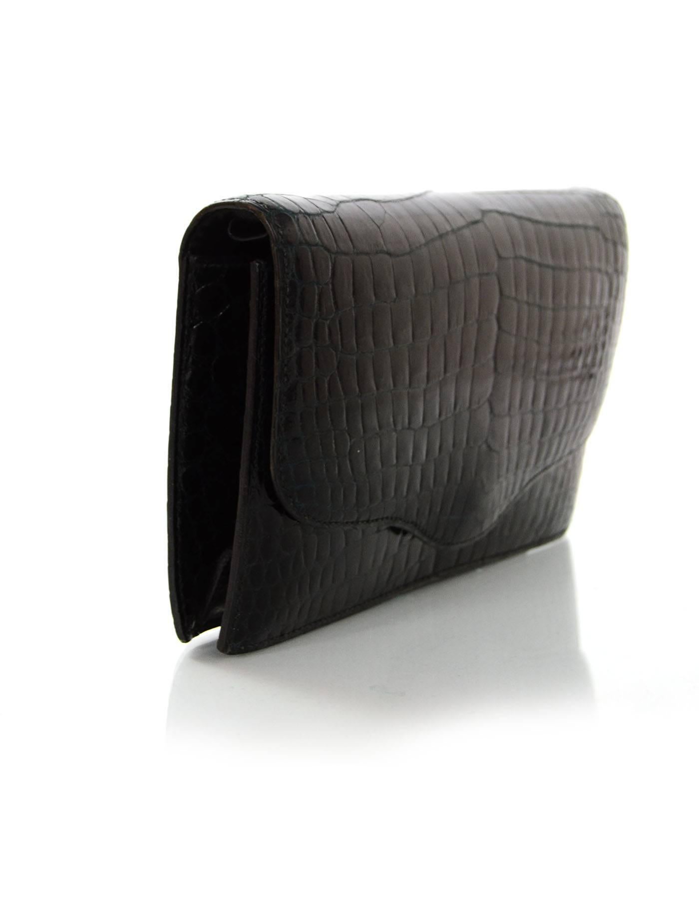 100% Authentic Hermes Black Porosus Crocodile Clutch. Features two small leather loops on interior of flap top- to create an evening shoulder bag

**NOTE: Chain in image not included**

Made In: France
Color: Black
Hardware: Goldtone
Materials: