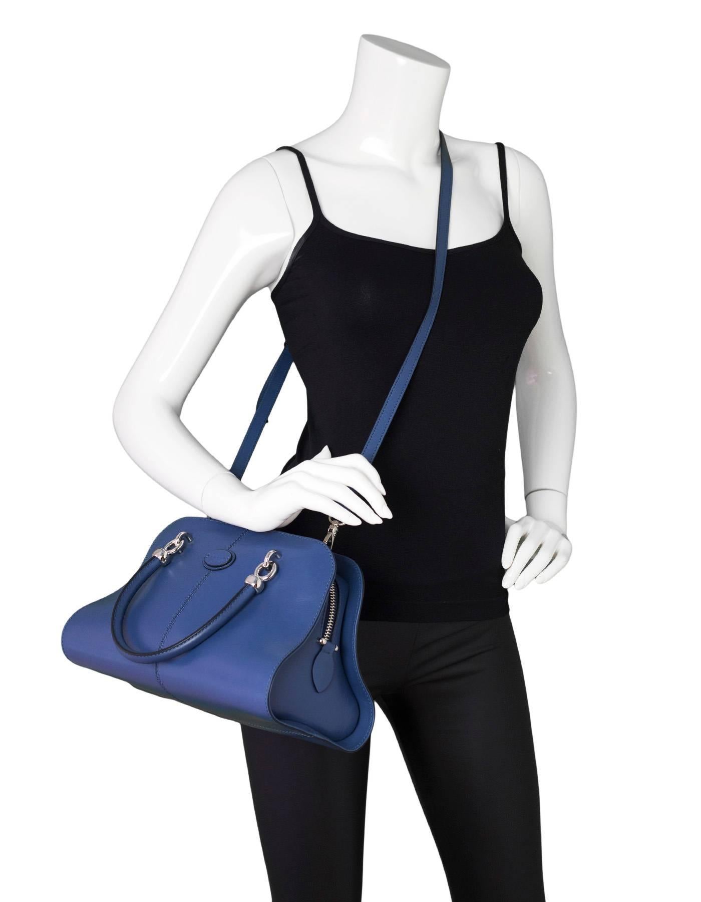 Tod's Blue Sella Bauletto Piccolo Satchel Bag 
Features optional shoulder strap

Made In: Italy
Color: Blue
Hardware: Silvetone
Materials: Leather, metal
Lining: Blue sateen
Closure/Opening: Zip top
Exterior Pockets: None
Interior Pockets: One zip