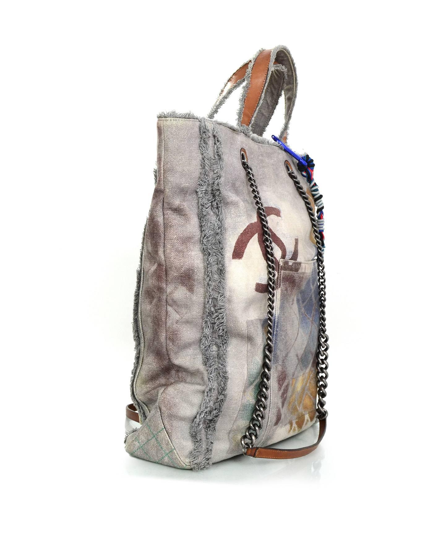 Chanel Grey Canvas Printed Graffiti Tote 
Features different text printed throughout and nylon twisted bag charm

Made In: Italy
Year of Production: 2014
Color: Grey and multi-colored
Hardware: Oxidized silvertone
Materials: Leather and