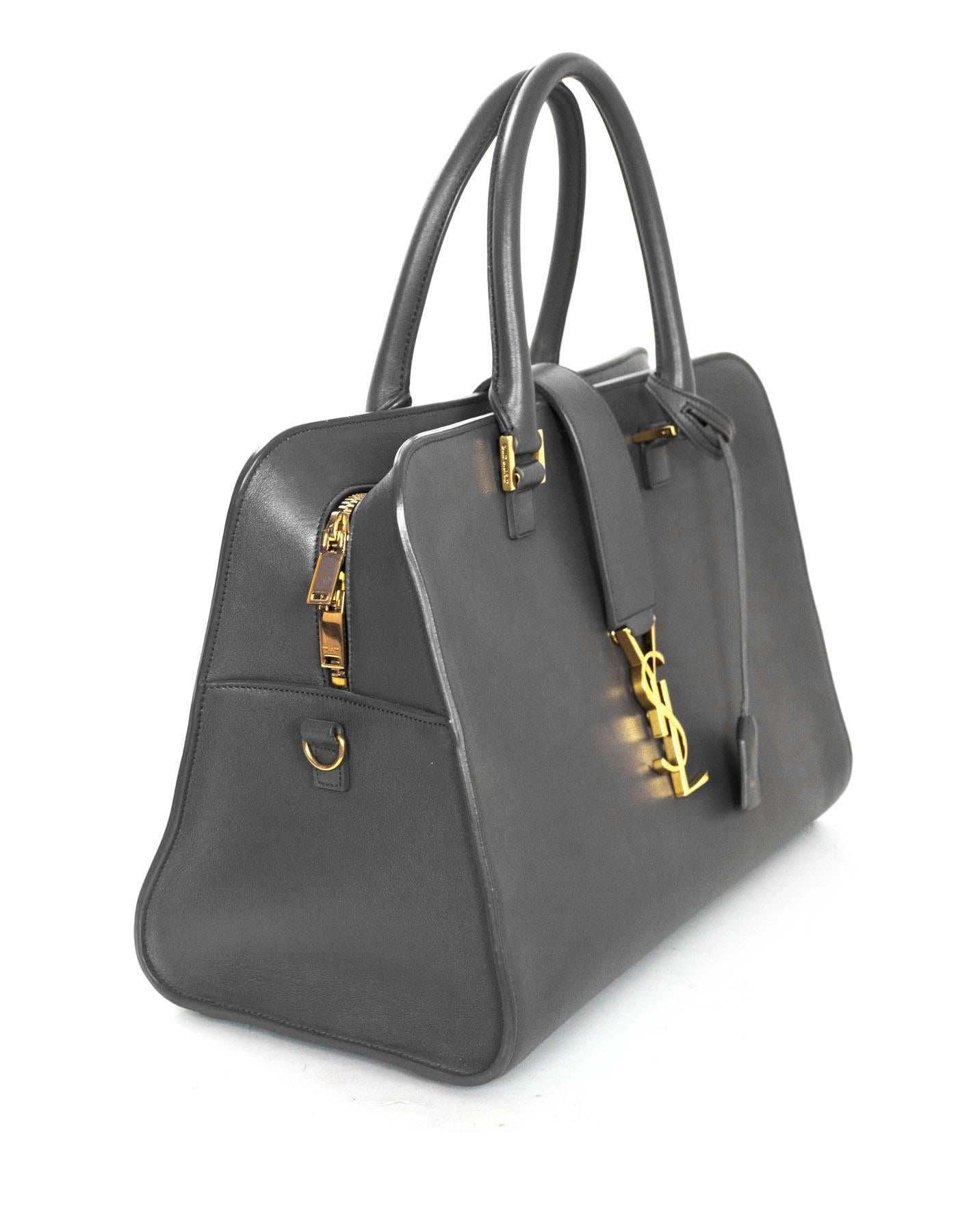 Saint Laurent Dark Anthracite Grey Medium Cabas Tote
Features goldtone YSL emblem on front

Made In: Italy
Color: Grey
Hardware: Goldtone
Materials: Leather, crystal and metal
Lining: Grey suede and leather
Closure/Opening: Double zip around closure