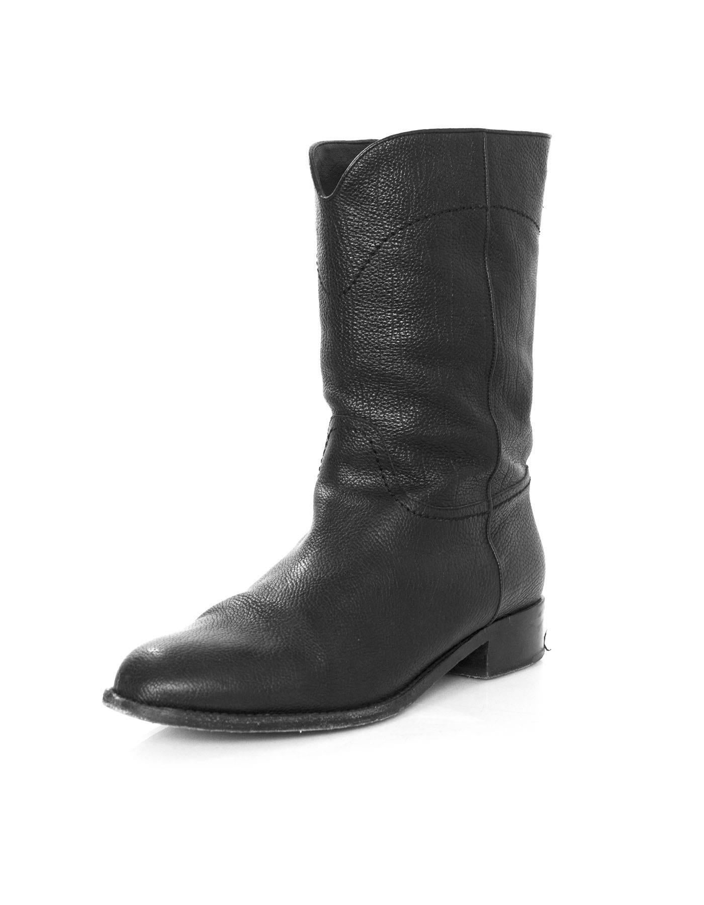 Chanel Black Leather Short Ascot Boots
Features CC stitched on back

Made In: Italy
Color: Black
Materials: Leather
Closure/Opening: Pull on
Sole Stamp: CC Made in Italy 42
Overall Condition: Excellent pre-owned condition with the exception of some