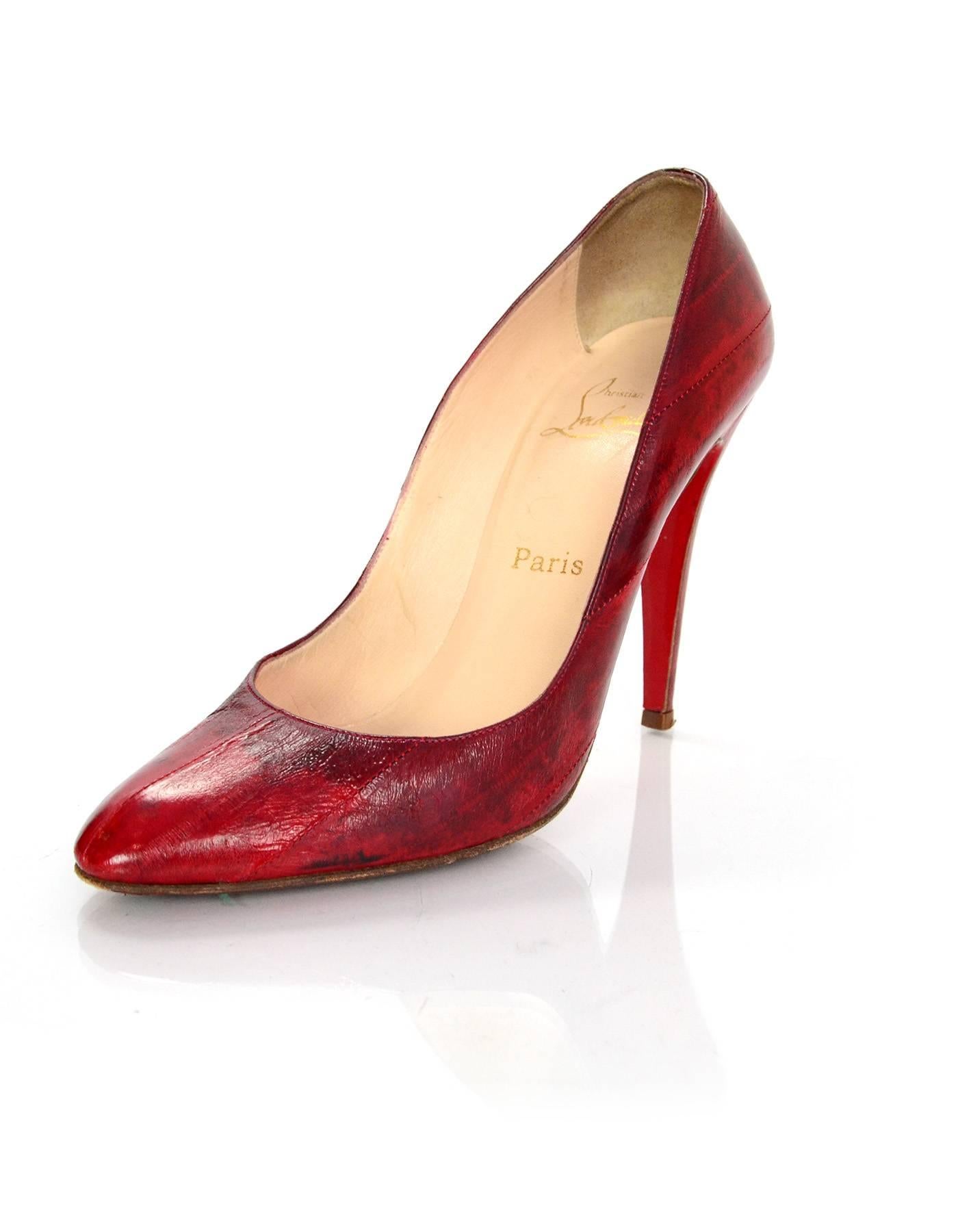 Christian Louboutin Red Eel Skin Pumps

Made In: Italy
Color: Red
Materials: Eel Skin
Closure/Opening: Slide on
Sole Stamp: Christian Louboutin Vero Cuoio Made in Italy 40
Overall Condition: Excellent pre-owned condition with the exception of