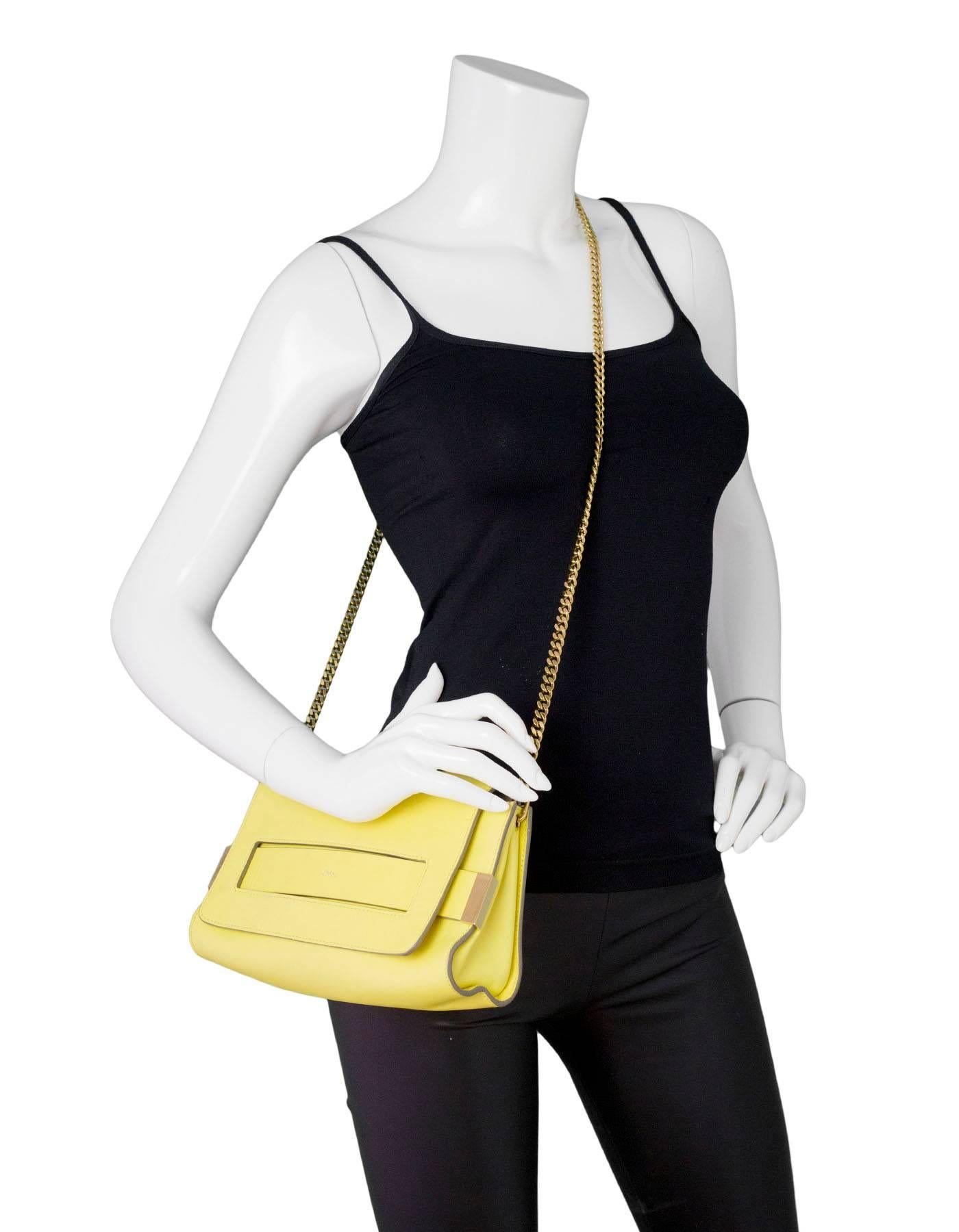 Chloe Yellow Leather Elle Crossbody Bag

Made In: Italy
Color: Yellow
Hardware: Goldtone
Materials: Leather, metal
Lining: Beige leather
Closure/Opening: Flap top with magnetic closure
Exterior Pockets: One front flap pocket
Interior Pockets: Three