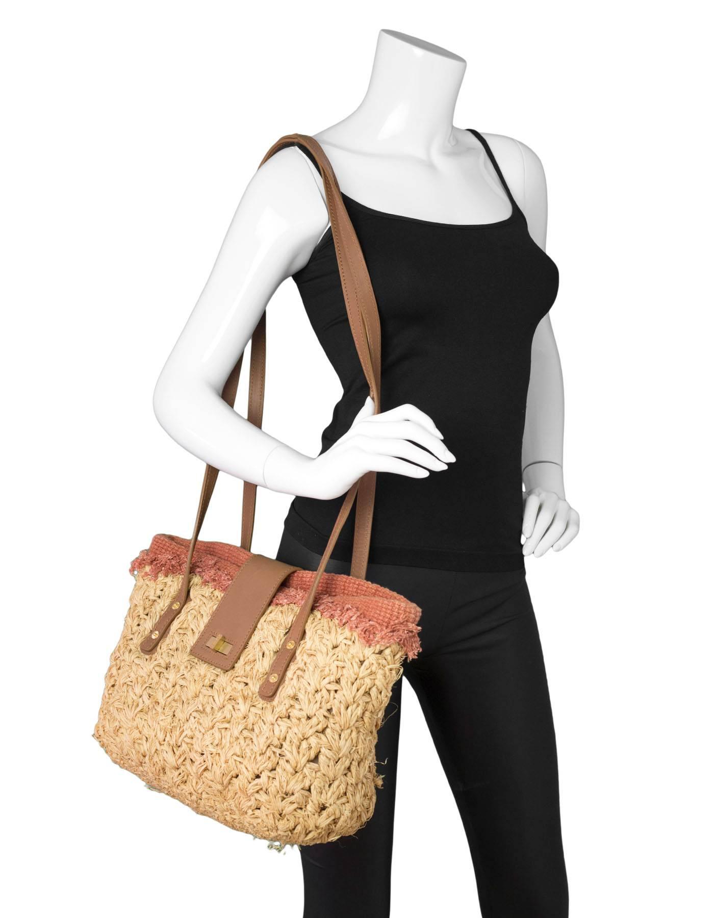 Chanel Braided Raffia Straw Tote

Made In: Italy
Year of Production: 2011
Color: Tan, brown
Hardware: Goldtone
Materials: Straw, leather
Lining: Brown textile
Closure/opening: Center flap with twist lock
Exterior Pockets: None
Interior Pockets: One