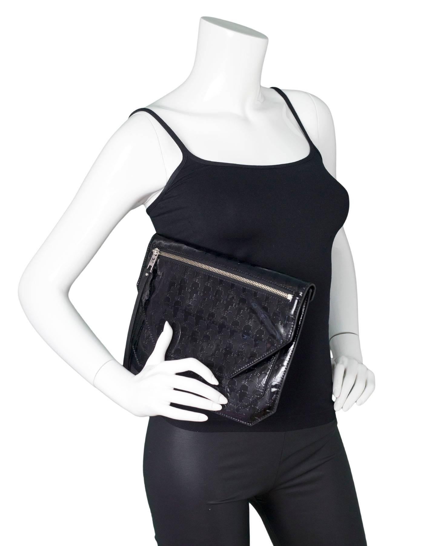 Karl Lagerfeld Black Patent Clutch

Color: Black
Hardware: Silvertone
Materials: Patent leather
Lining: Pink textile
Closure/Opening: Flap top with snap closure
Exterior Pockets: Front zip pocket
Interior Pockets: Two compartments, one wall