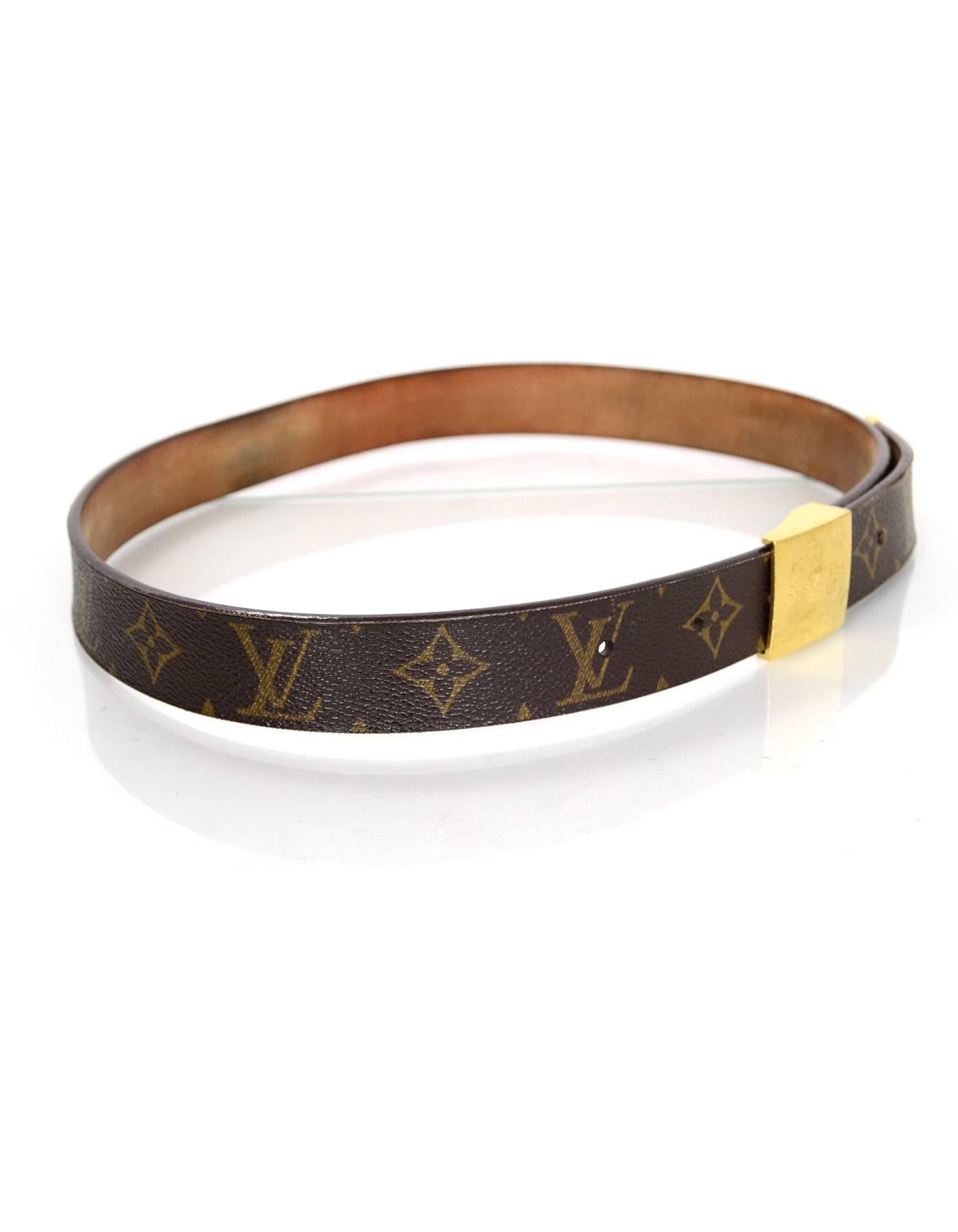 Louis Vuitton Ceinture Carre Belt 

Made In: Buckle- France Belt- Spain
Year of Production: 2001
Color: Tan and brown
Hardware: Goldtone
Materials: Coated canvas and leather
Closure/Opening: Stud and notch closure
Stamp: LB1021
Overall Condition: