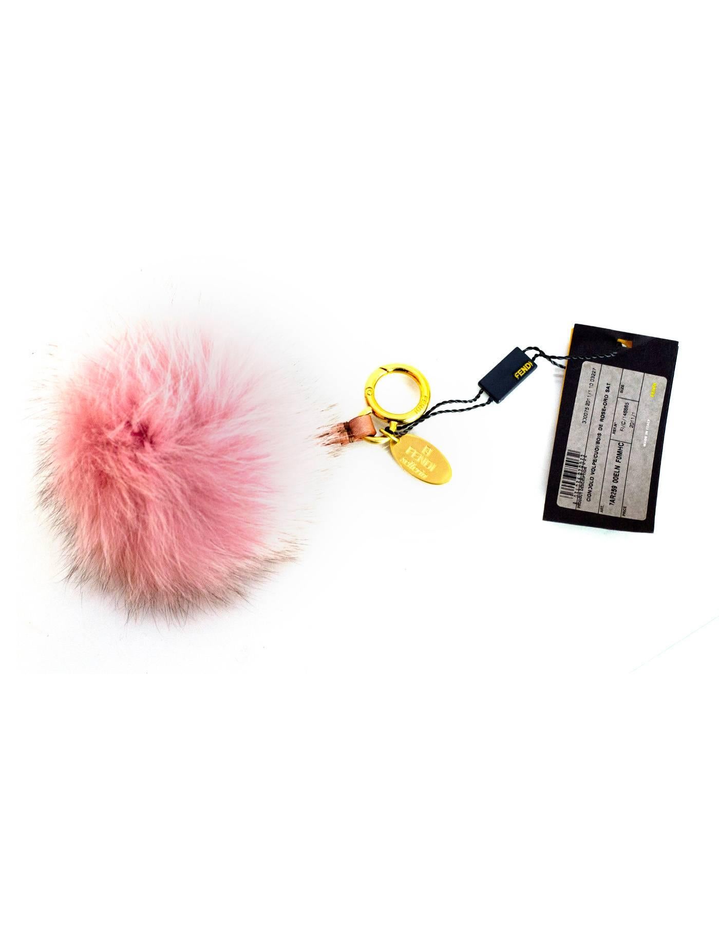 Fendi NEW Fox Fur Selleria Pom Pom Bag Charm 
Features metallic mauve leather strap

Color: Mauve/pink
Hardware: Goldtone
Materials: Fox fur, leather and metal
Closure/Opening: Jump ring push lever
Overall Condition: Excellent- NEW
Includes: Fendi