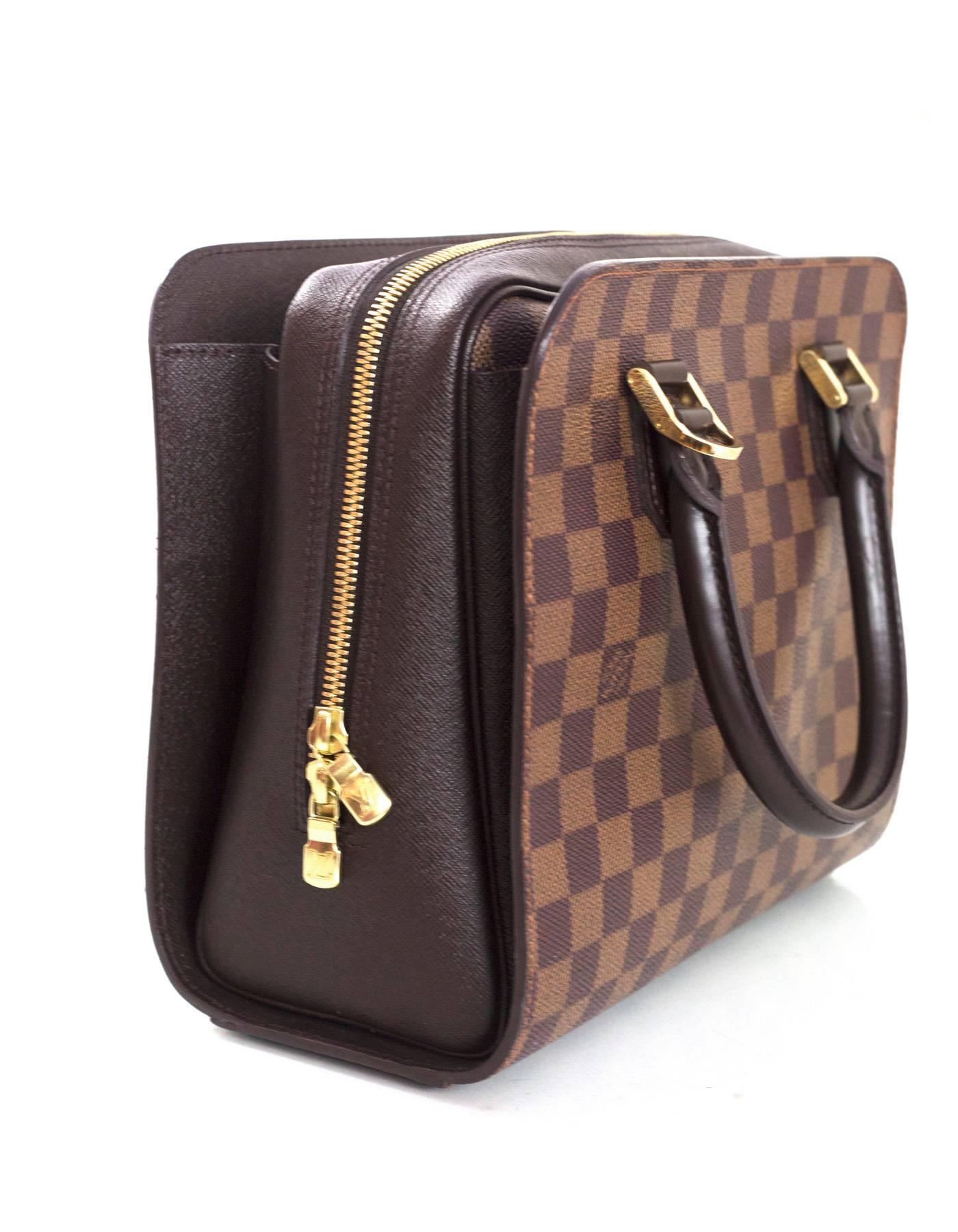 Louis Vuitton Damier Ebene Triana Top Handle Bag 
Features leather wrapped handles

Made In: France
Year of Production: 2000
Color: Brown
Hardware: Goldtone
Materials: Coated canvas and leather
Lining: Burnt orange microfiber
Closure/Opening: Zip