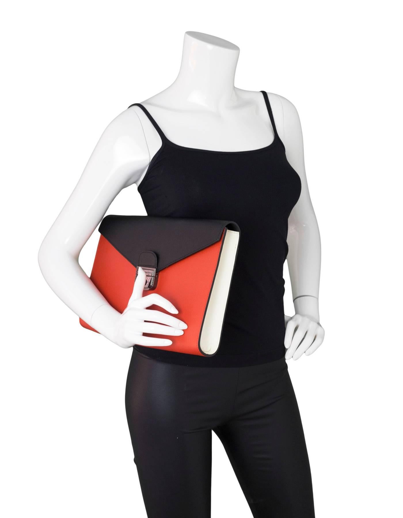 Longchamp Le Pliage Heritage Three-Tone Clutch

Made In: France
Color: Black, cream, red
Hardware: Gunmetal
Materials: Leather, metal
Lining: Black textile
Closure/Opening: Flap top with push-lock closure
Exterior Pockets: Snap pocket at