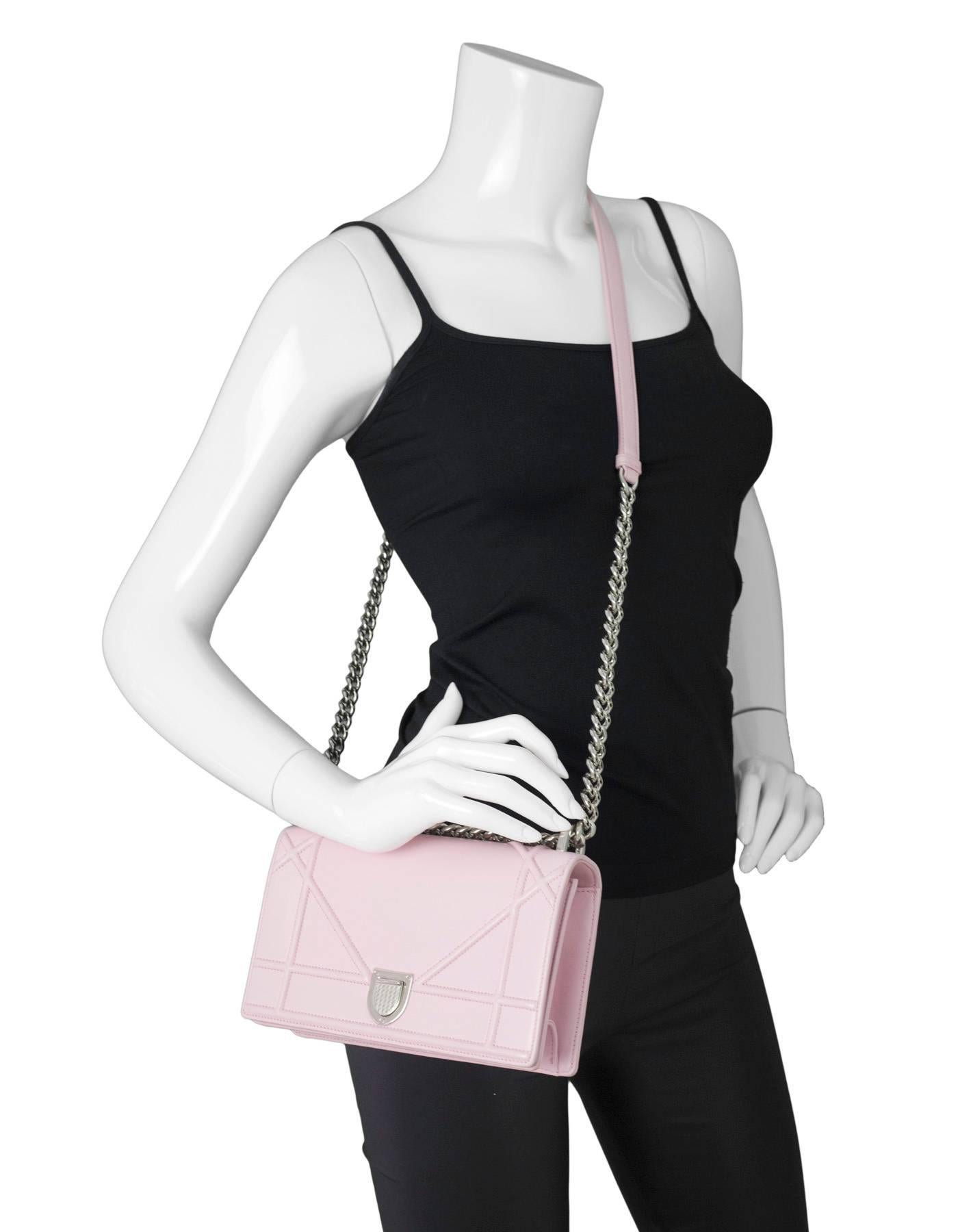 Christian Dior Pink Diorama Flap Bag
Features adjustable shoulder bag

Made In: Italy
Color: Pink
Materials: Leather, metal
Opening: Flap top with push lock
Exterior Pockets: None
Interior Pockets: One zip pocket, one wall pocket
Retail Price: