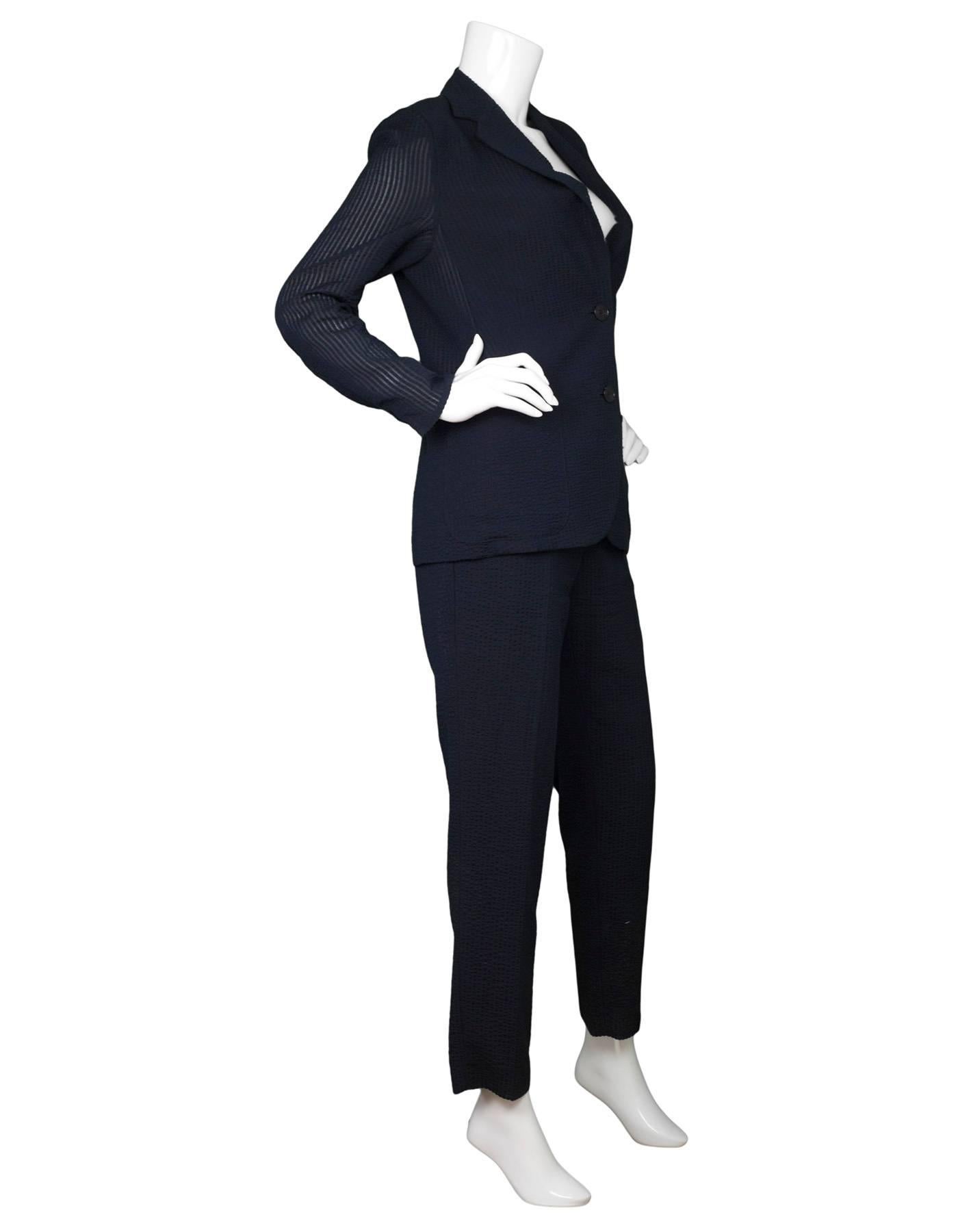Akris Navy Seersucker Pantsuit Sz 8

Made In: Romania
Color: Navy
Composition: 51% mulberry silk, 39% wool, 7% polyester, 2% nylon, 1% polyurethane
Lining: 100% viscose
Closure/Opening: Jacket: front double button / Pants: front zip and hidden hook