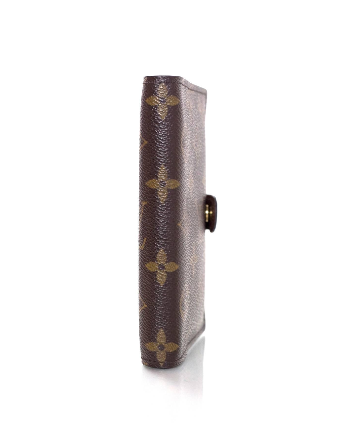 Louis Vuitton Monogram Small Ring Agenda Cover
Features 3 rings for agenda on interior with attached small ruler

Made In: USA
Year of Production: 2003
Color: Brown
Hardware: Goldtone
Materials: Coated canvas
Lining: Brown coated