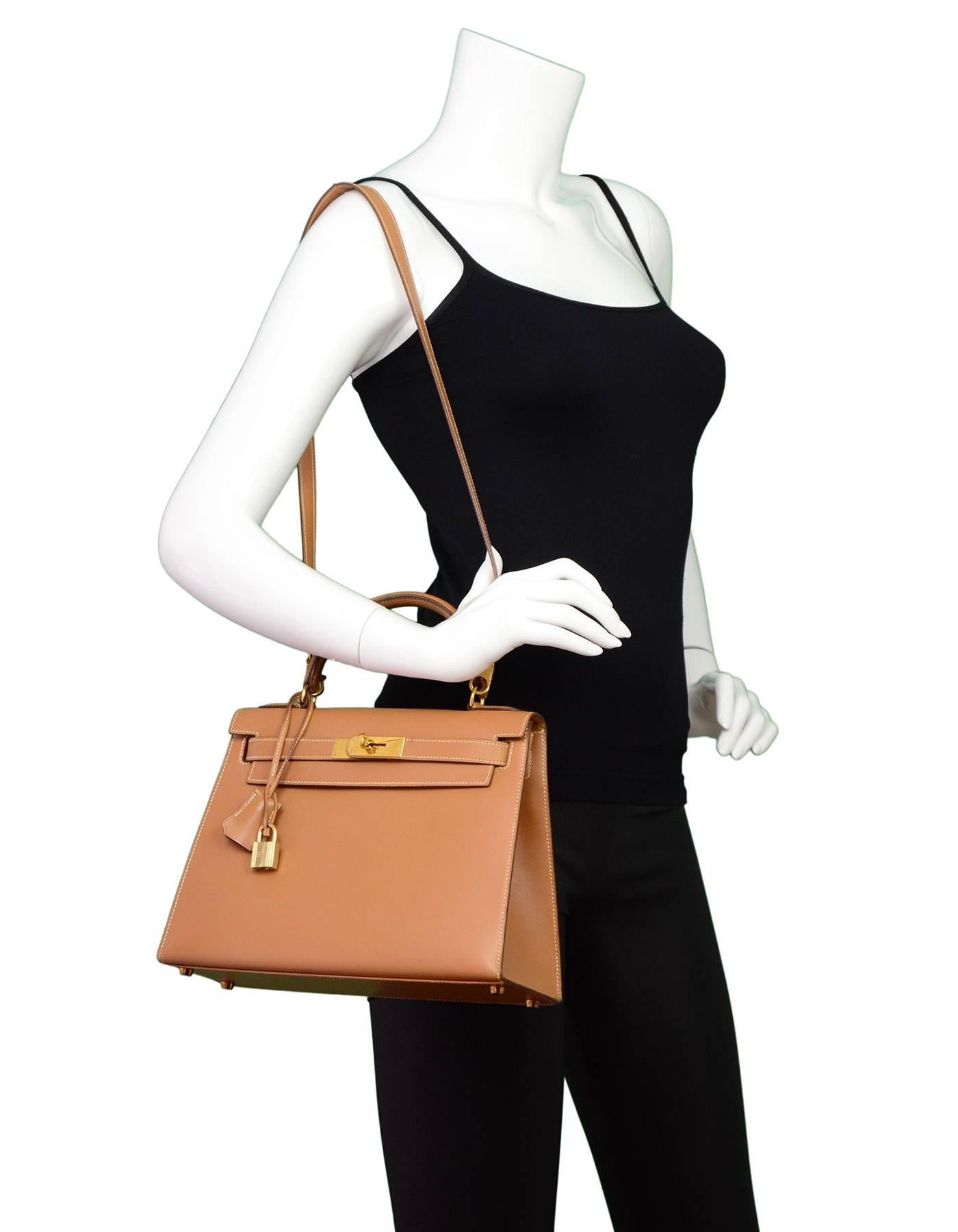 Hermes Tan Box 28cm Rigid Sellier Kelly Bag
Features removable shoulder/crossbody strap

Made In: France
Year of Production: 1992
Color: Tan
Hardware: Goldtone
Materials: Box leather, metal
Lining: Tan leather
Closure/opening: Flap top with two