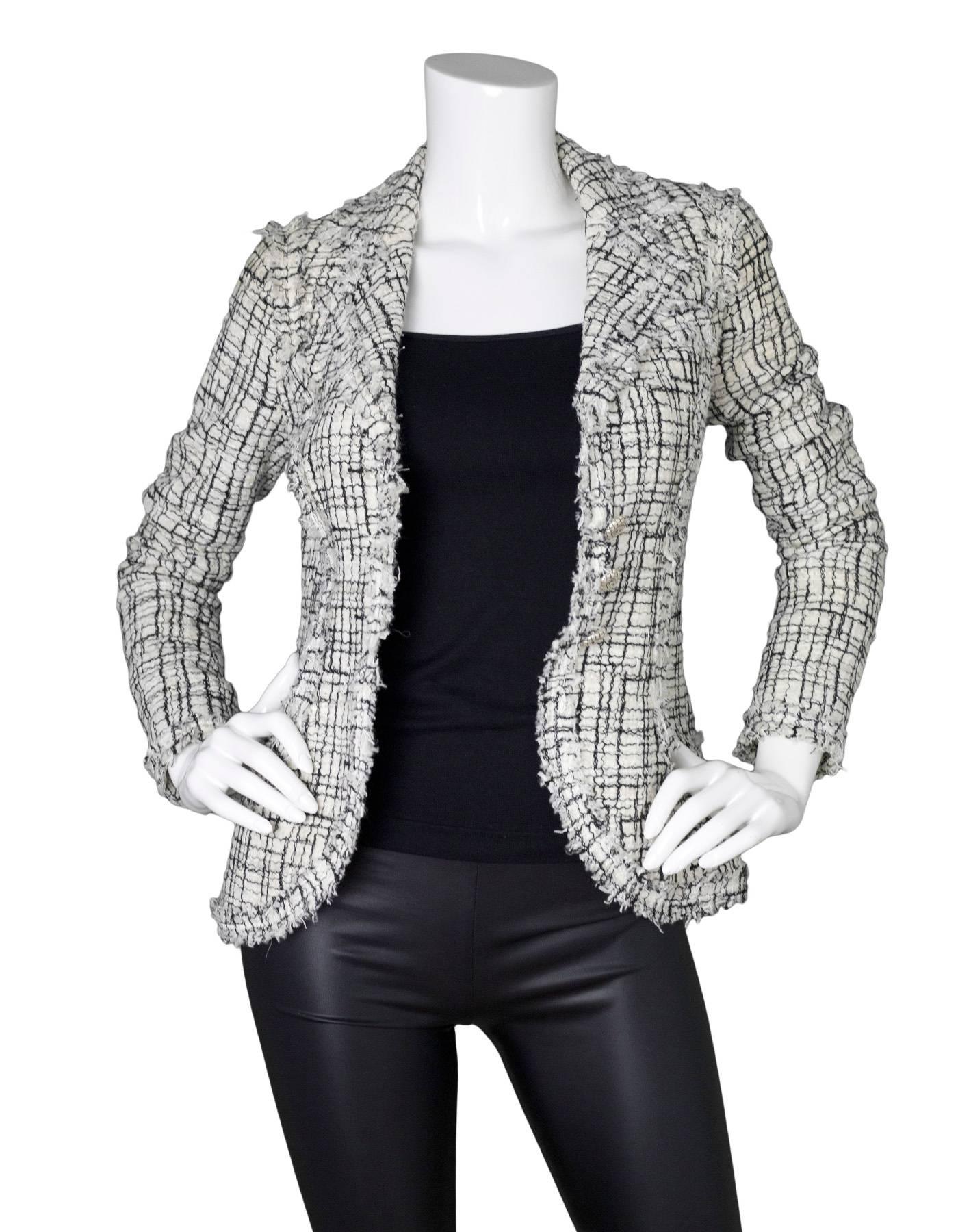 Chanel Black & White Tweed Jacket

Made In: France
Year of Production: 2006
Color: Black and white
Composition: 53% cotton, 12% polyethylene, 12% rayon, 10% acetate, 5% nylon, 5% silk, 3% wooll
Lining: White, 96% silk, 4%