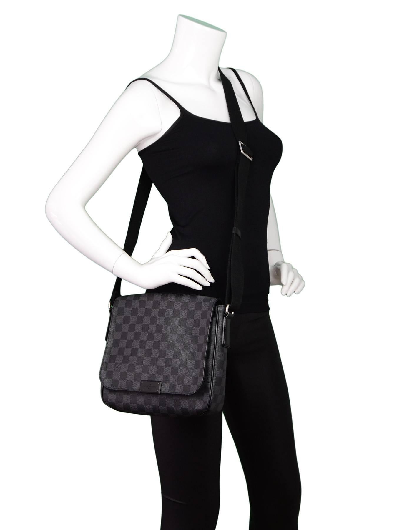 Louis Vuitton Graphite Damier District PM Crossbody Bag

Made In: France
Year of Production: 2014
Color: Black and charcoal
Hardware: Silvertone
Materials: Coated canvas and leather trim
Lining: Black textile
Closure/Opening: Flap top with magnetic