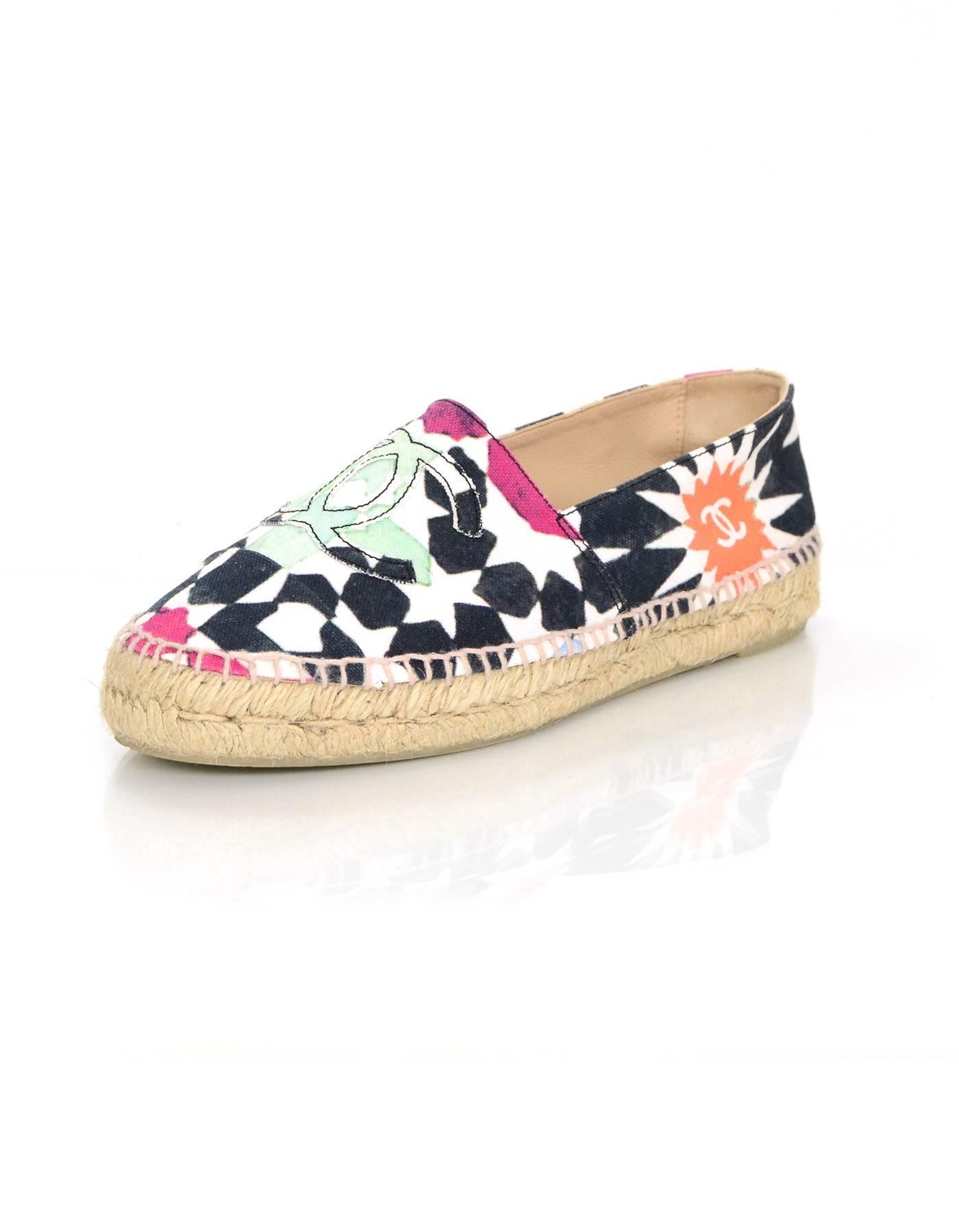 Chanel Multi-Colored Star Print Canvas Espadrilles
Features multi-colored CC's stitched on toe cap

Made In: Spain
Color: White, navy, orange, purple and teal
Materials: Canvas
Closure/Opening: Slide on
Sole Stamp: 39 Made in Spain Chanel CC
Overall
