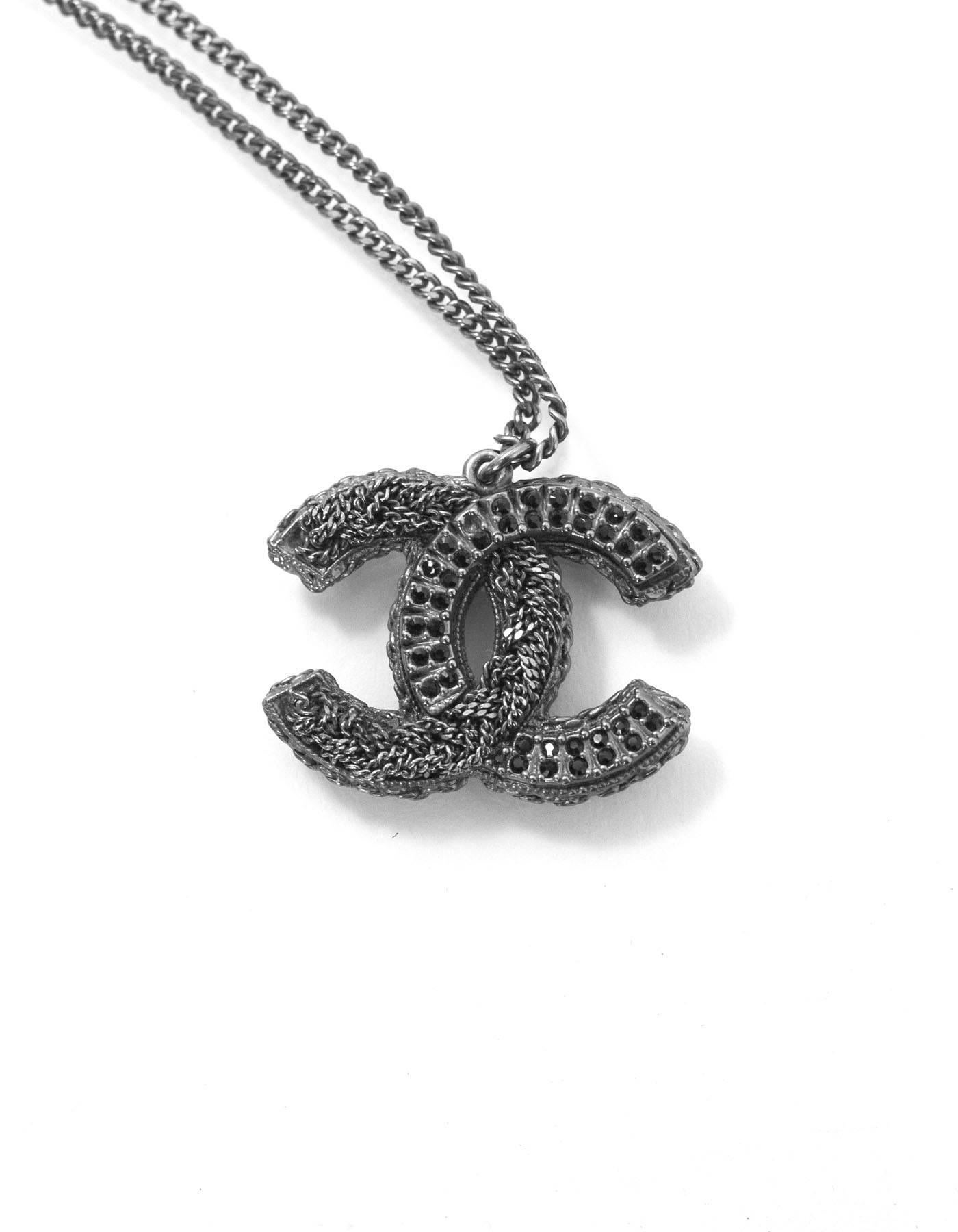 Chanel Gunmetal & Black Crystal CC Pendant Necklace
Features crystal and chain detail on one side and black enamel on other of CC pendant

Made In: France
Year of Production: 2011
Color: Gunmetal and black
Materials: Metal and crystal
Closure: