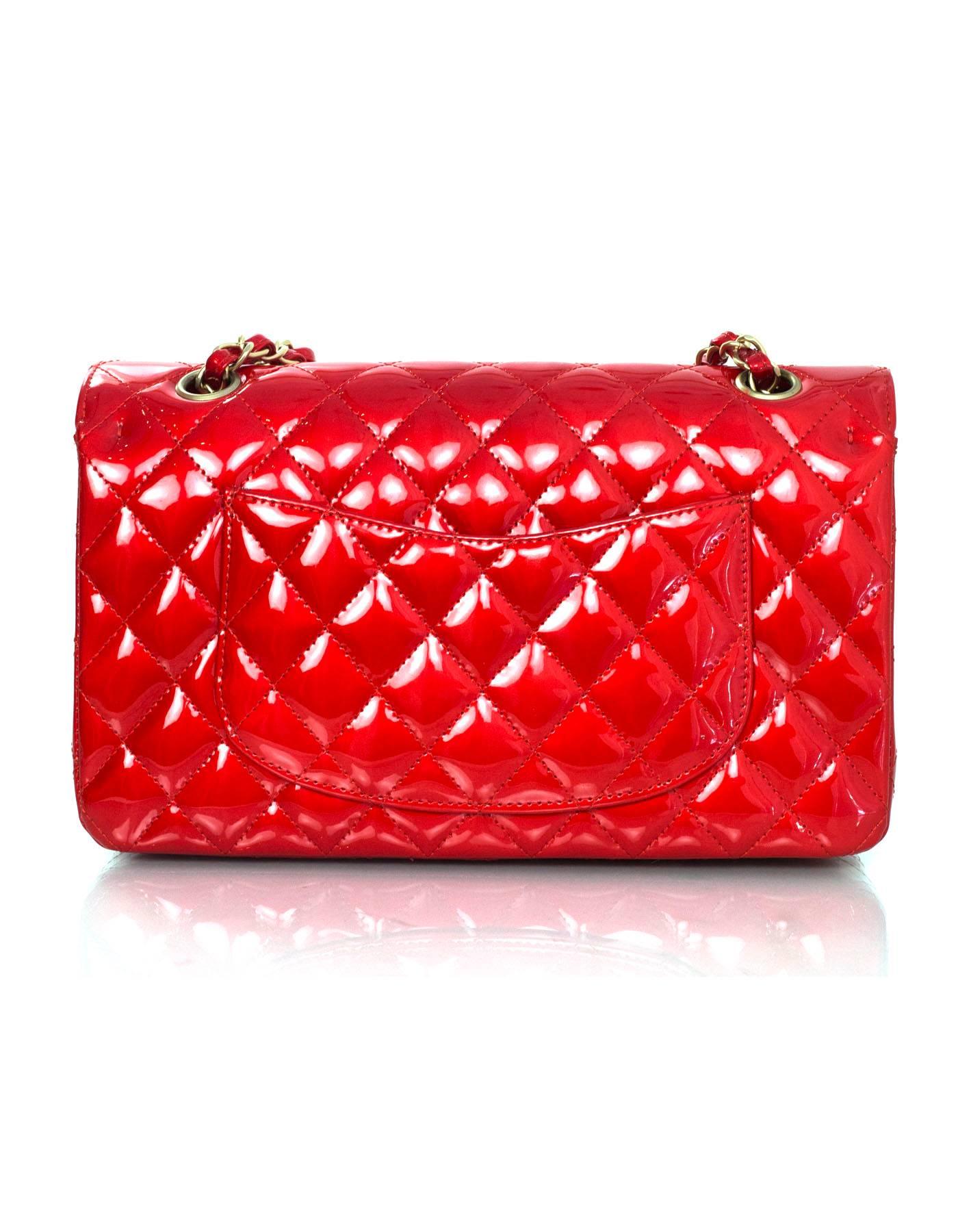 Chanel Collector's Mobile Art Show Red Patent 10" Classic Double Flap Bag
Features Karl Lagerfeld's signature on inside of bag 

Made In: France
Year of Production: 2008
Color: Red
Hardware: Goldtone
Materials: Patent leather and metal
Lining: