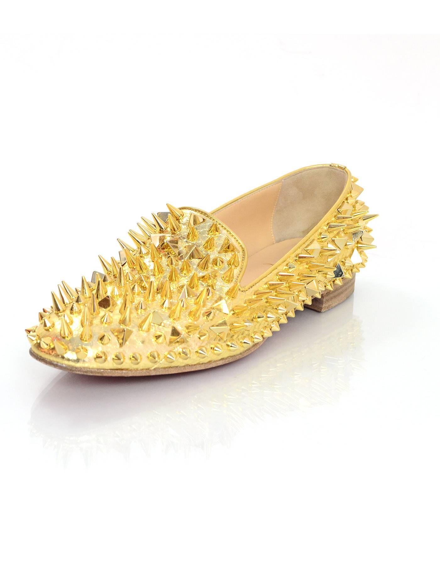 Christian Louboutin Gold Spiked Loafers Sz 38.5

Made In: Italy
Color: Gold
Materials: Snakeskin, spikes
Closure/Opening: Slide on
Sole Stamp: Christian Louboutin Made in Italy 38.5
Overall Condition: Excellent pre-owned condition with the exception