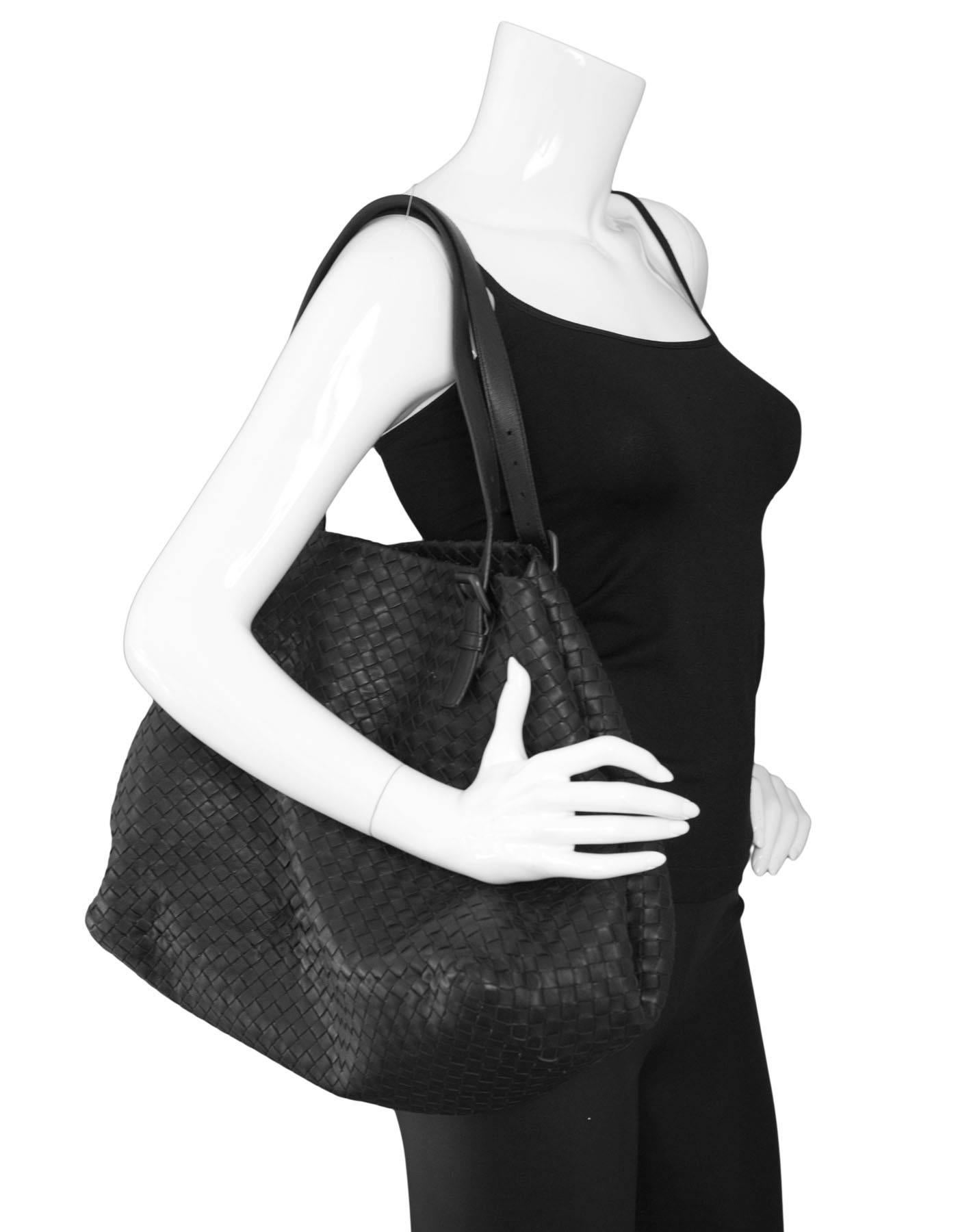 Bottega Veneta Black Intrecciato Large Tote Bag

Made In: Italy
Color: Black
Hardware: Black
Materials: Leather
Lining: Taupe suede
Closure/Opening: Open top with center hook closure
Exterior Pockets: None
Interior Pockets: One zip pocket and one