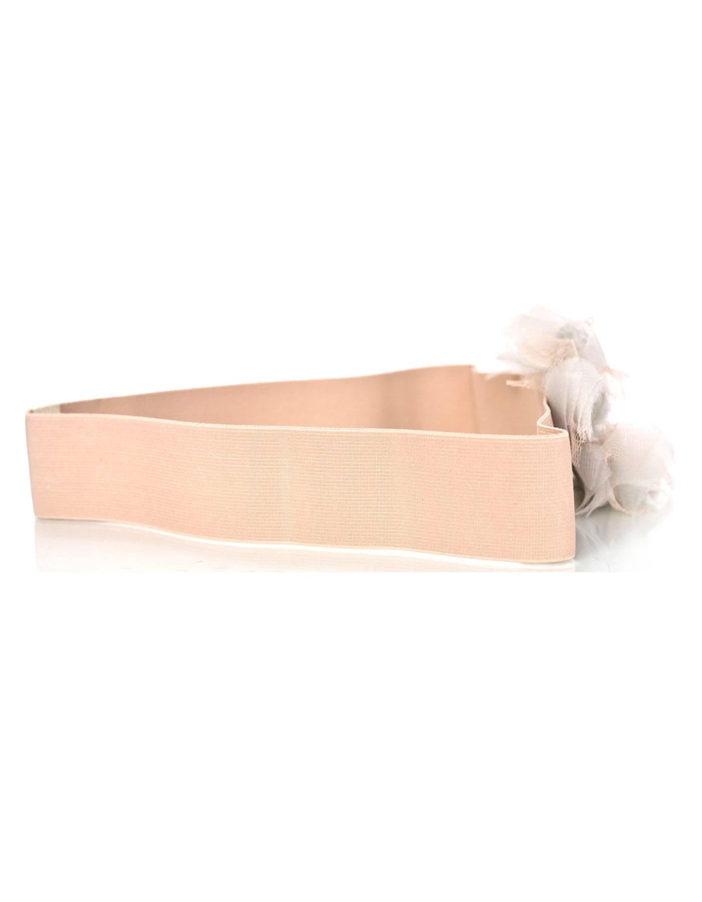 Lanvin Blush Elastic Belt 
Features pale blue tulle flower

Made In: France
Color: Blush and pale blue
Materials: Elastic and tulle
Closure/Opening: Double snap closure
Stamp: Lanvin Made in France
Overall Condition: Excellent pre-owned condition