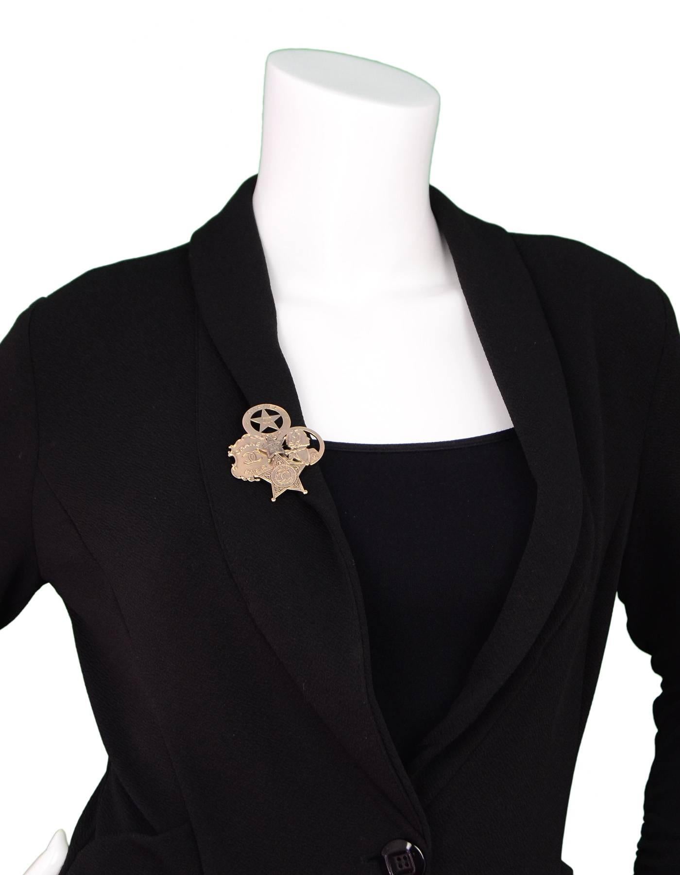 Chanel Paris/Dallas Badge Brooch

Made In: Italy
Year of Production: 2014
Hardware: Goldtone
Materials: Metal
Closure: Pin back closure
Stamp: Chanel B14 CC A Made in Italy
Overall Condition: Excellent pre-owned condition 
Includes: Chanel box and