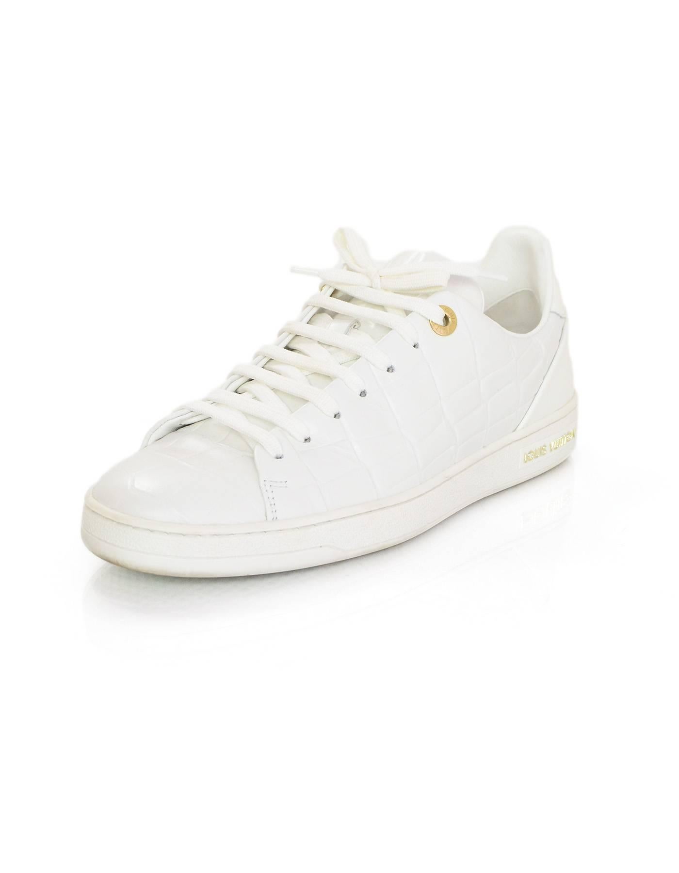 Louis Vuitton White Embossed Frontrow Sneakers Sz 38.5
Features embossed crocodile leather

Color: White
Materials: Leather, rubber
Closure/Opening: Lace tie closure
Sole Stamp: Louis Vuitton Paris
Retail Price: $680 + tax
Overall Condition: