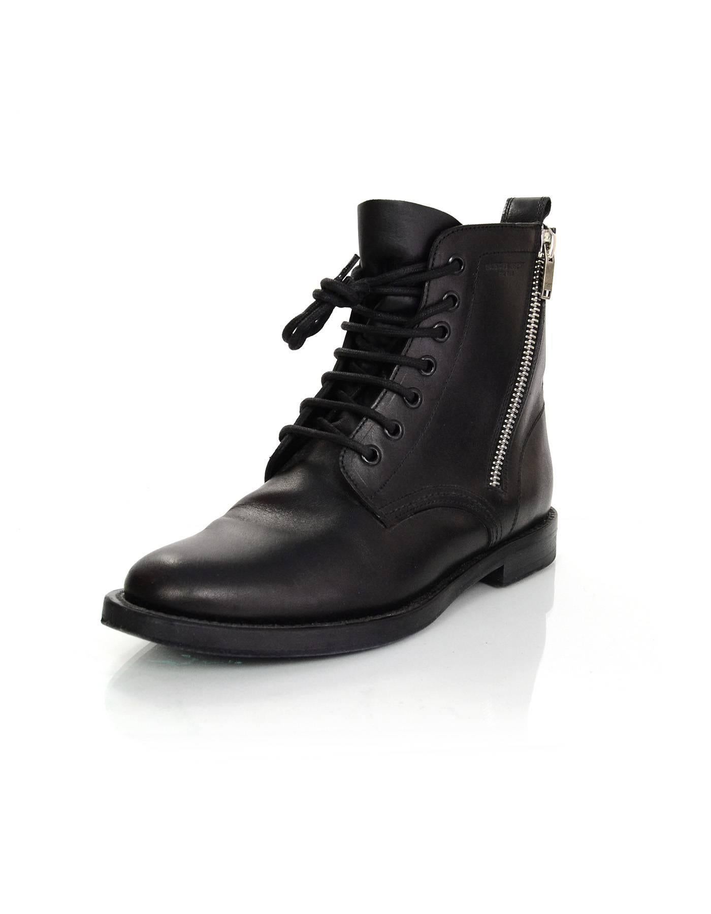 Saint Laurent Black Leather Combat Ankle Boots Sz 38.5
Features zippers at sides

Made In: Italy
Color: Black
Materials: Leather
Closure/Opening: Lace tie closure / side sip
Sole Stamp: Saint Laurent Paris 38.5
Retail Price: $1,295 + tax
Overall