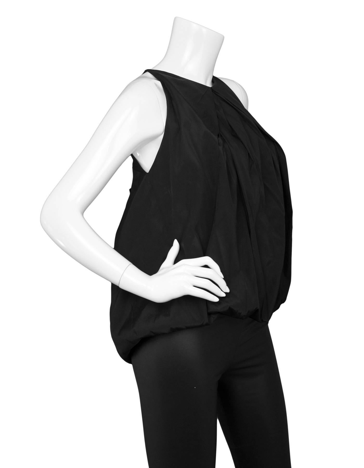 Donna Karan Black Silk Sleeveless Balloon Top 
Features bow at back

Made In: China
Color: Black 
Composition: 100% silk
Lining: Black, 100% viscose
Closure/Opening: Pull over
Exterior Pockets: None
Interior Pockets: None
Overall Condition: