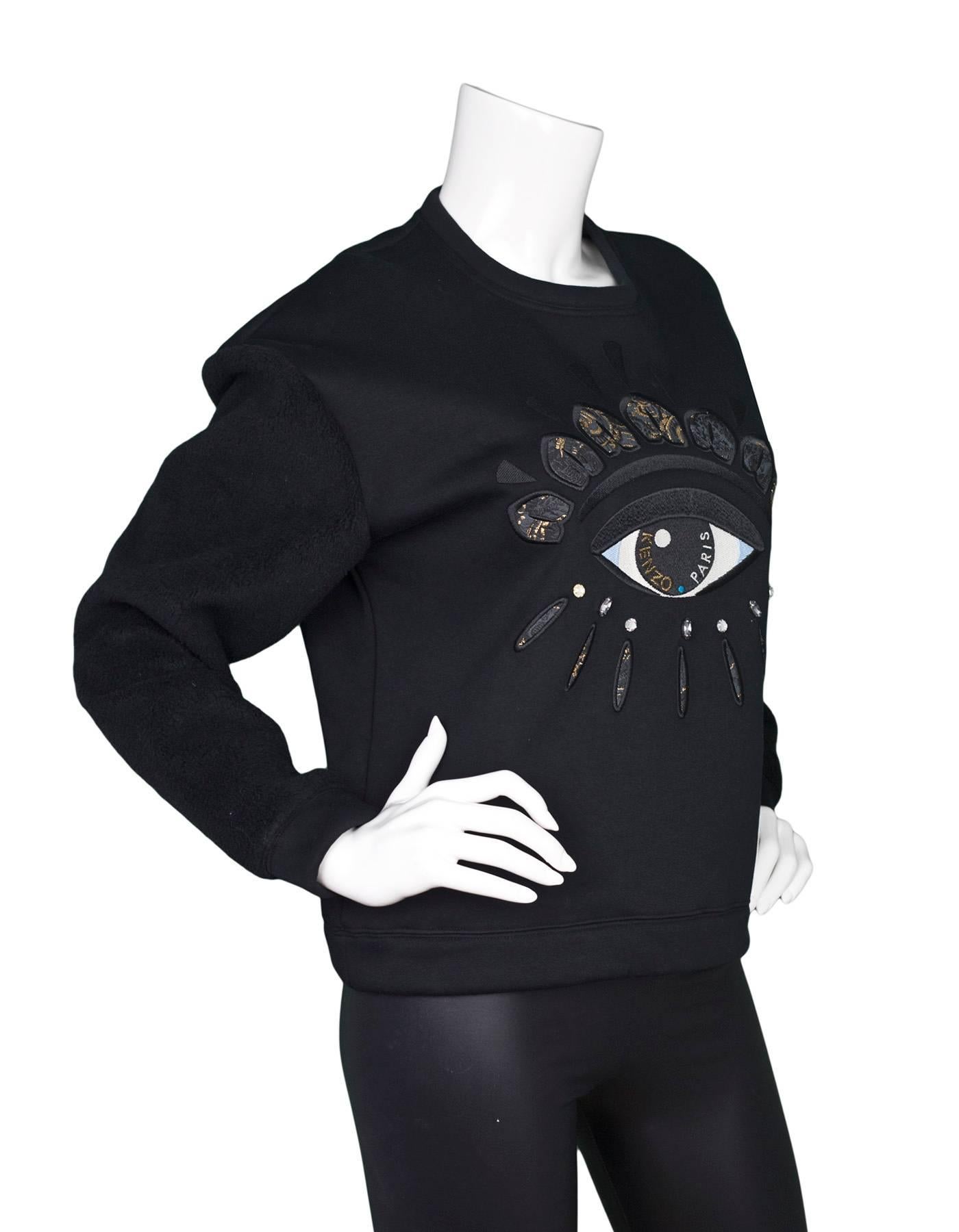 Kenzo Black Eye Embellished Sweatshirt Sz S
Features fleece-like sleeves

Made In: Portugal
Color: Black
Composition: 60% Polyester, 38% Cotton, 2% Elastane
Closure/Opening: Pull-over
Retail Price: $470 + tax
Overall Condition: Excellent pre-owned