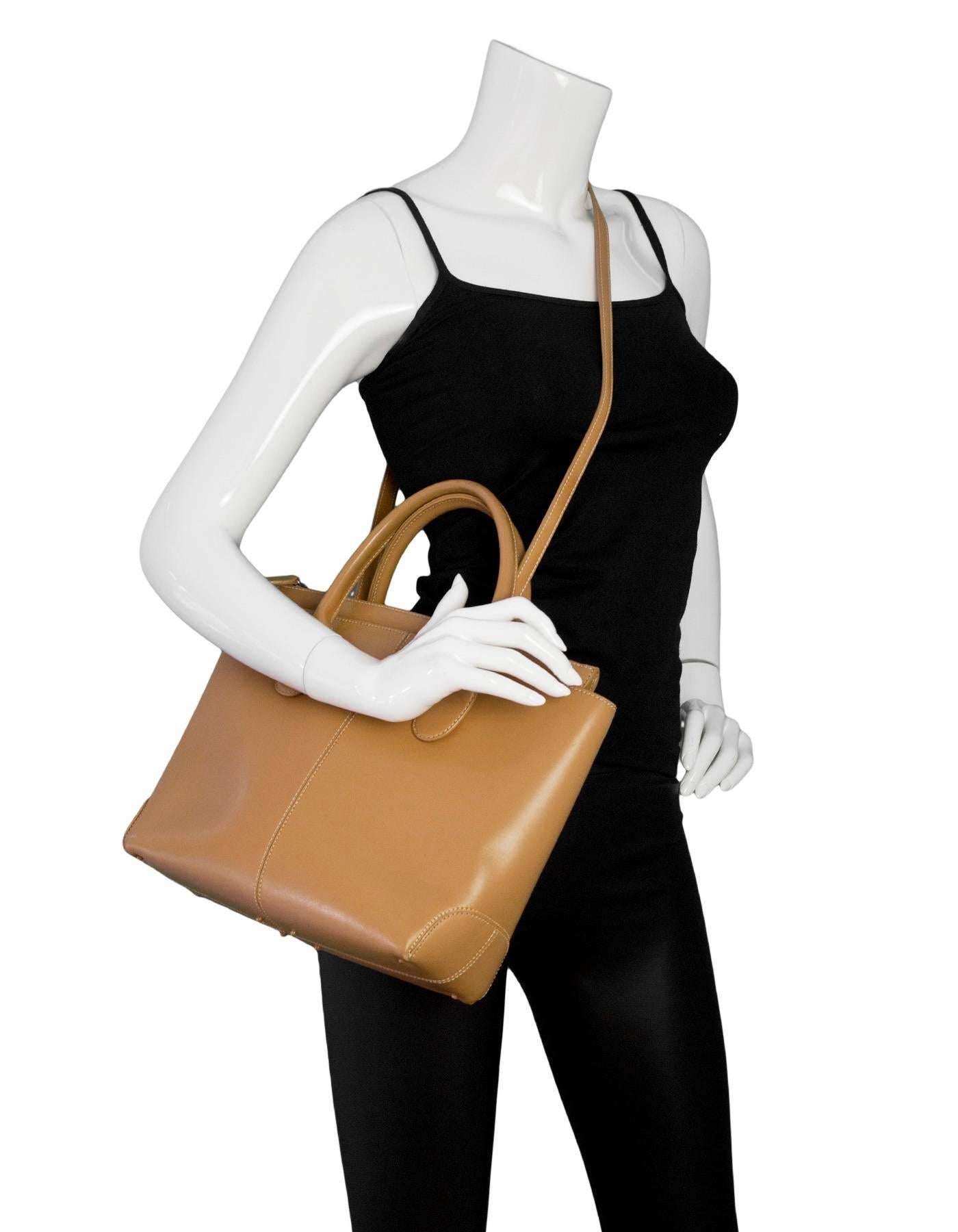 Tod's Camel Leather Tote
Features optional shoulder strap

Made In: Italy
Color: Camel
Materials: Leather, metal
Lining: Beige textile
Closure/Opening: Zip top
Exterior Pockets: None
Interior Pockets: One zip wall pocket
Overall Condition: Very good