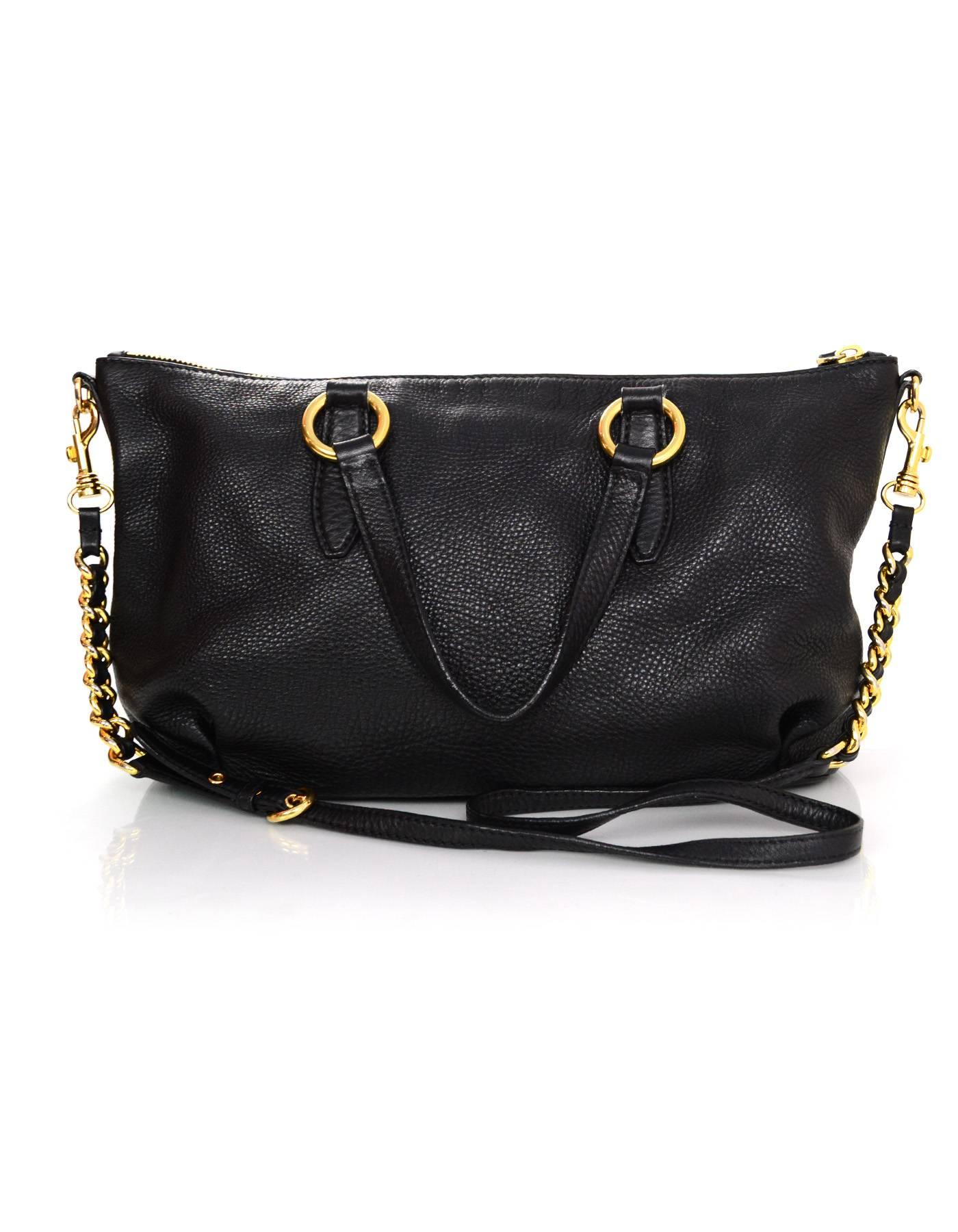 Miu Miu Black Leather Tote
Featuers optional shoulder/crossbody strap

Made In: Turkey
Color: Black
Hardware: Goldtone
Materials: Leather
Lining: Black nylon blend fabric
Closure/Opening: Zip across top
Exterior Pockets: None
Interior Pockets: One