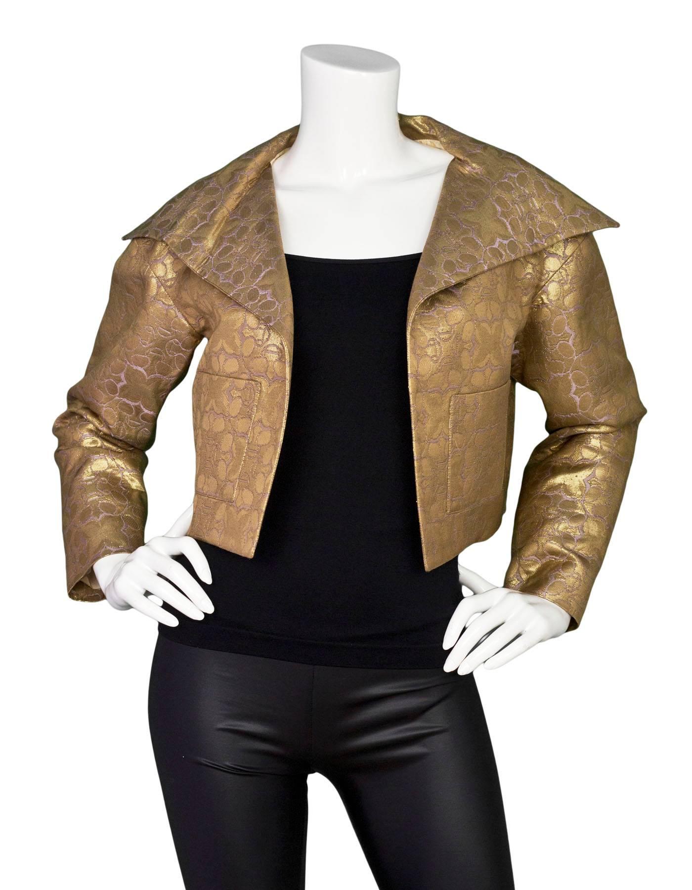 Carolina Herrera Gold Brocade Cropped Jacket

Made In: USA
Color: Gold and purple
Composition: 43% silk, 25% wool, 23% polyacrylic, 9% polyester
Lining: Champagne, silk
Closure/Opening: None- Open front
Exterior Pockets: Two patch pockets
Interior