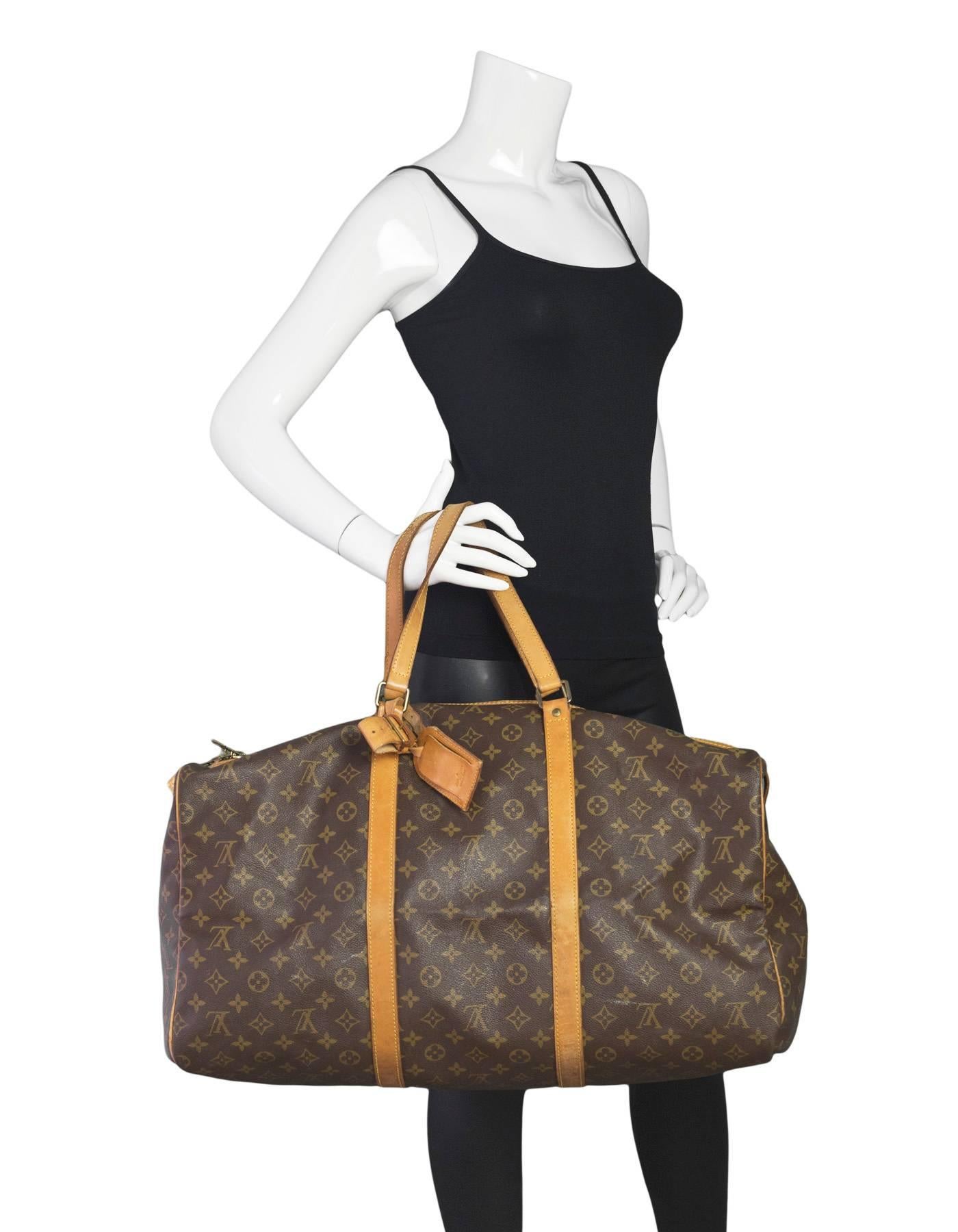 Louis Vuitton Vintage Monogram Keepall 55

Made In: France
Year of Production: Vintage - pre 1980
Color: Brown and tan
Hardware: Goldtone
Materials: Coated canvas and vachetta leather
Lining: Brown canvas
Closure/Opening: Double zip across