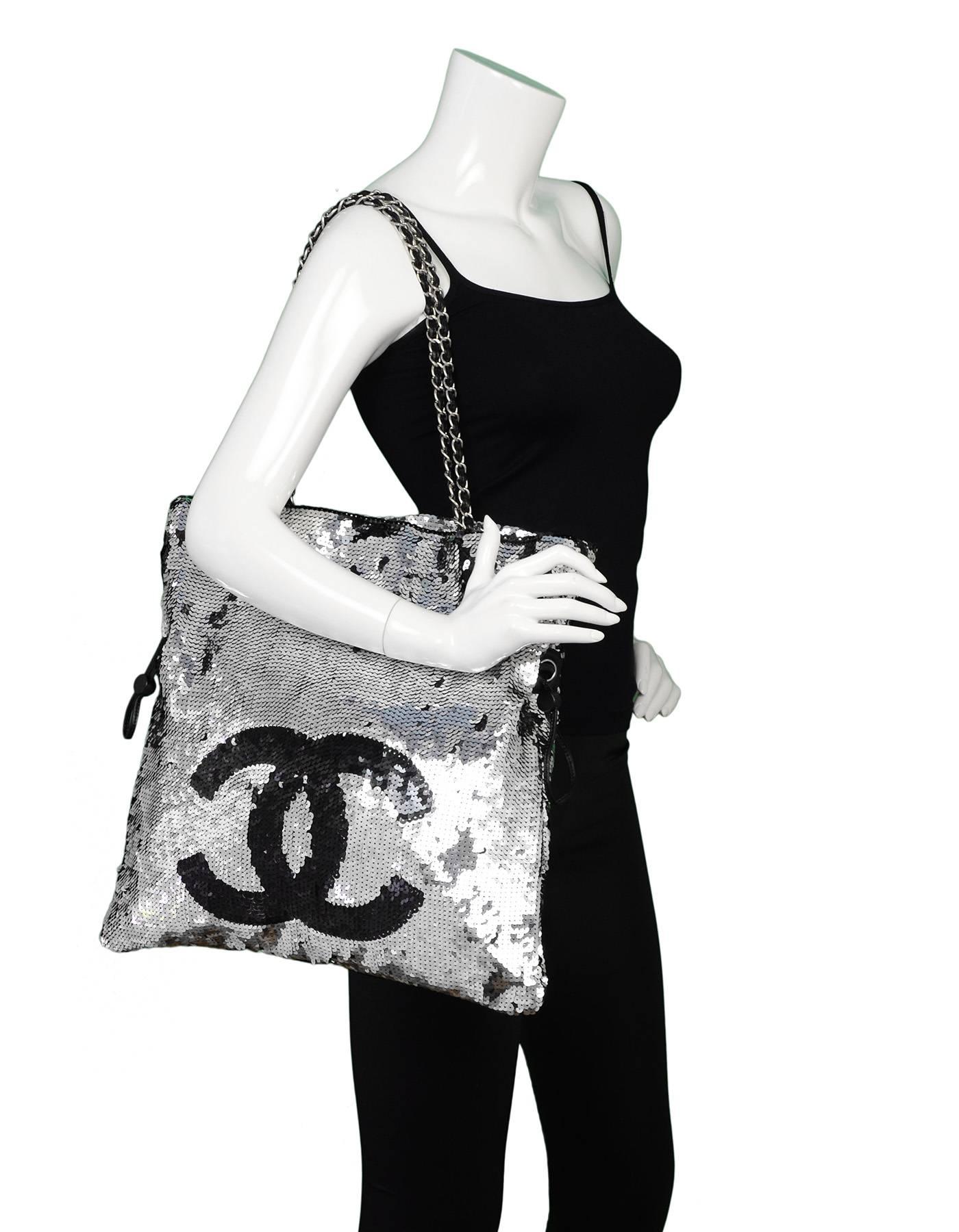 Chanel Silver and Black Sequined Summer Nights Tote Bag

Made In: Italy
Year of Production: 2005-2006
Color: Silver, black
Hardware: Silvertone
Materials: Sequin, leather, metal
Lining: Black textile
Closure/opening: Open top with center snap