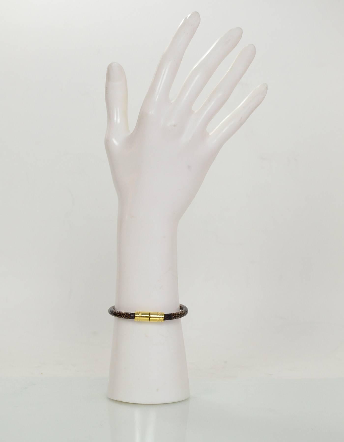 Louis Vuitton Damier Keep It Bracelet

Color: Brown
Hardware: Goldtone
Materials: Coated canvas, metal
Closure: Push clasp
Retail Price: $220 + tax
Overall Condition: Excellent pre-owned condition with the exception of light tarnish at