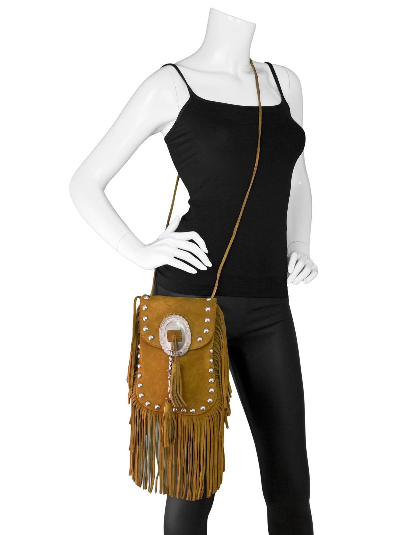 Saint Laurent Tan Suede Anita Fringe Crossbody Bag
Features fringe throughout and western accents

Made In: Italy
Color: Tan
Hardware: Silvertone
Materials: Suede, metal
Lining: Suede
Closure/Opening: Flap top
Exterior Pockets: None
Interior