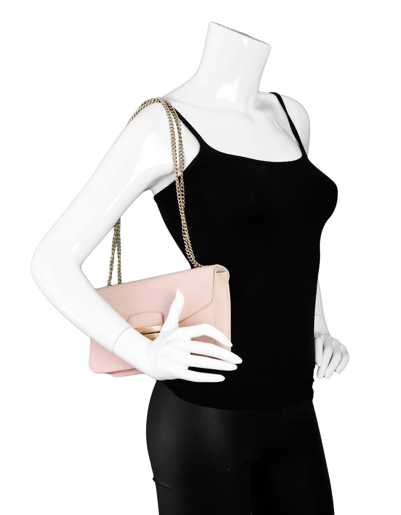 Furla Pink Saffiano Julia Pochette Shoulder Bag

Made In: Bulgaria
Color: Light pink
Hardware: Goldtone
Materials: Saffiano leather, metal
Lining: Pink textile
Closure/Opening: Push lock closure
Exterior Pockets: None
Interior Pockets: One zip