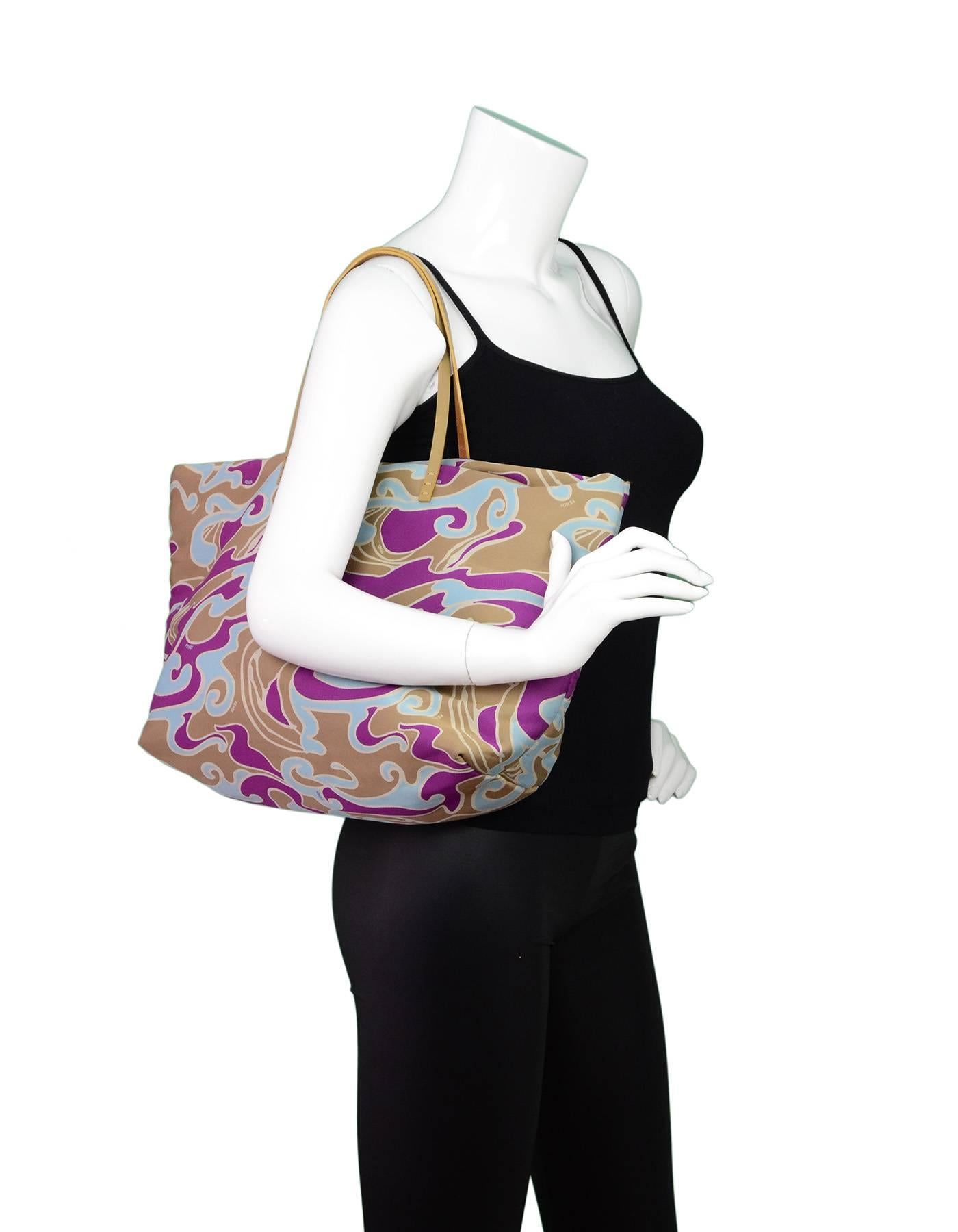 Fendi Multi-Color Abstract Print Tote Bag

Made In: Italy
Color: Purple, blue, taupe
Hardware: Goldtone
Materials: Sateen
Lining: Blue sateen
Closure/Opening: Open top with center snap
Exterior Pockets: None
Interior Pockets: One zip wall