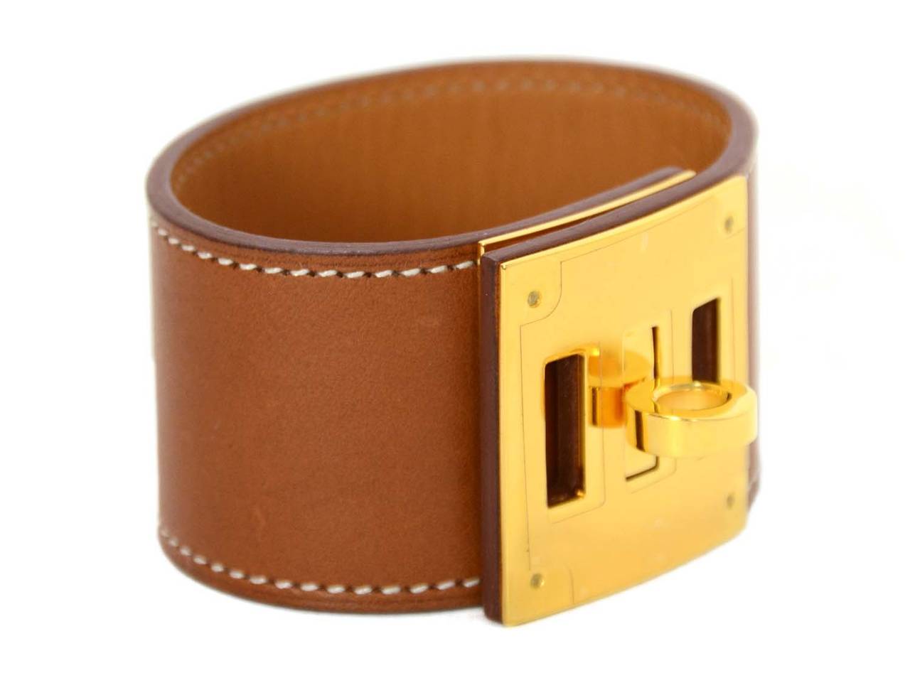 Hermes '13 Fauve Barenia Leather Kelly Dog Bracelet
Features three notch closure for adjustable size

    Made in: France
    Year of Production: 2013
    Stamp: N stamp, Q stamp in square
    Closure: Turn lock closure
    Color: Fauve brown