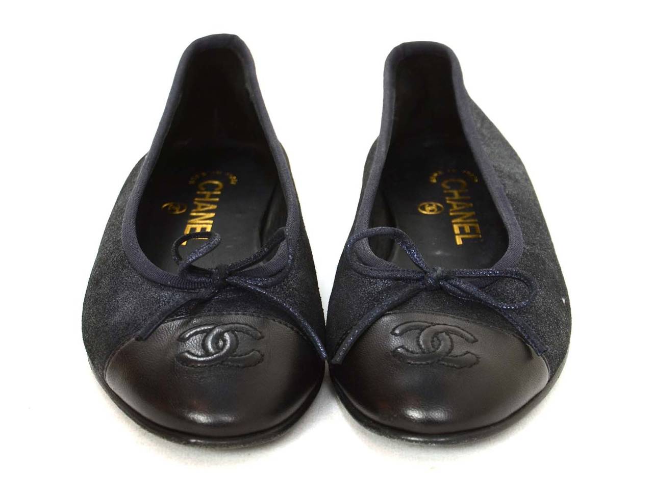 Chanel Metallic Navy Ballet Flats w/Bow sz 37
Features embossed CC black leather covered toe

    Made in: Italy
    Color: Navy and black
    Composition: Black leather and metallic textile
    Sole Stamp: CC Made in Italy
   