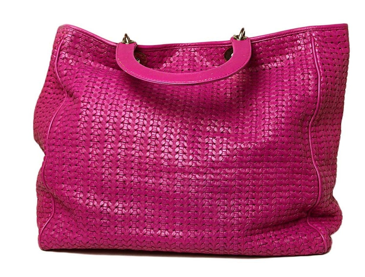 -Made in: France
-Color: Dark pink/fuschia
-Materials: Soft woven leather
-Hardware: Silver-tone
-Lining: Pink leather
-Serial Number: 236-BM-0078
-Exterior Pockets: None
-Interior Pockets: One zipper and one cellphone
-Closure: Open with
